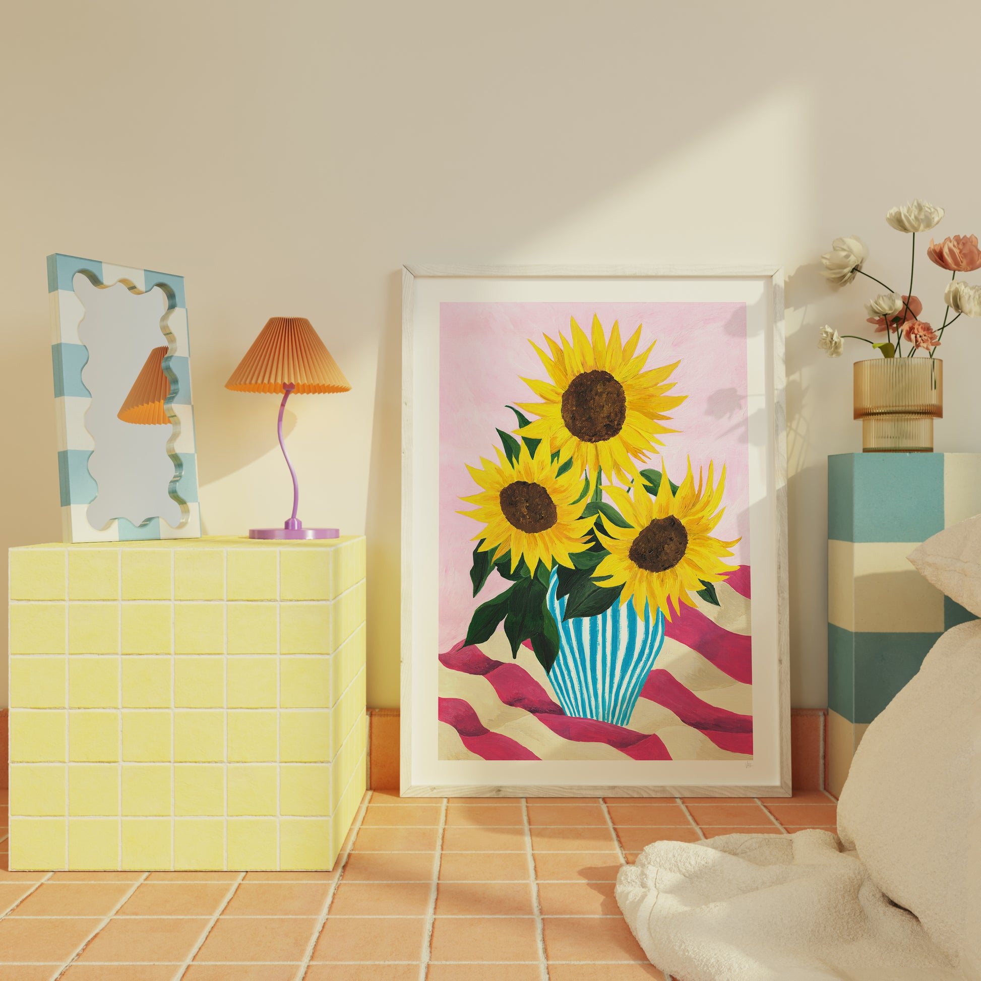 Framed artwork of sunflowers in a room with a lamp and decorative items.