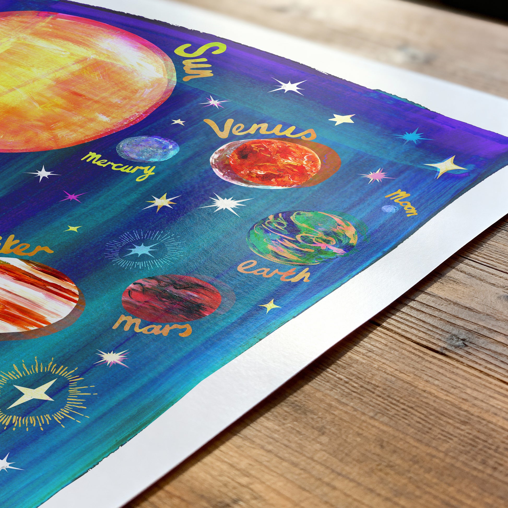 Colorful illustration of the solar system on a wooden surface