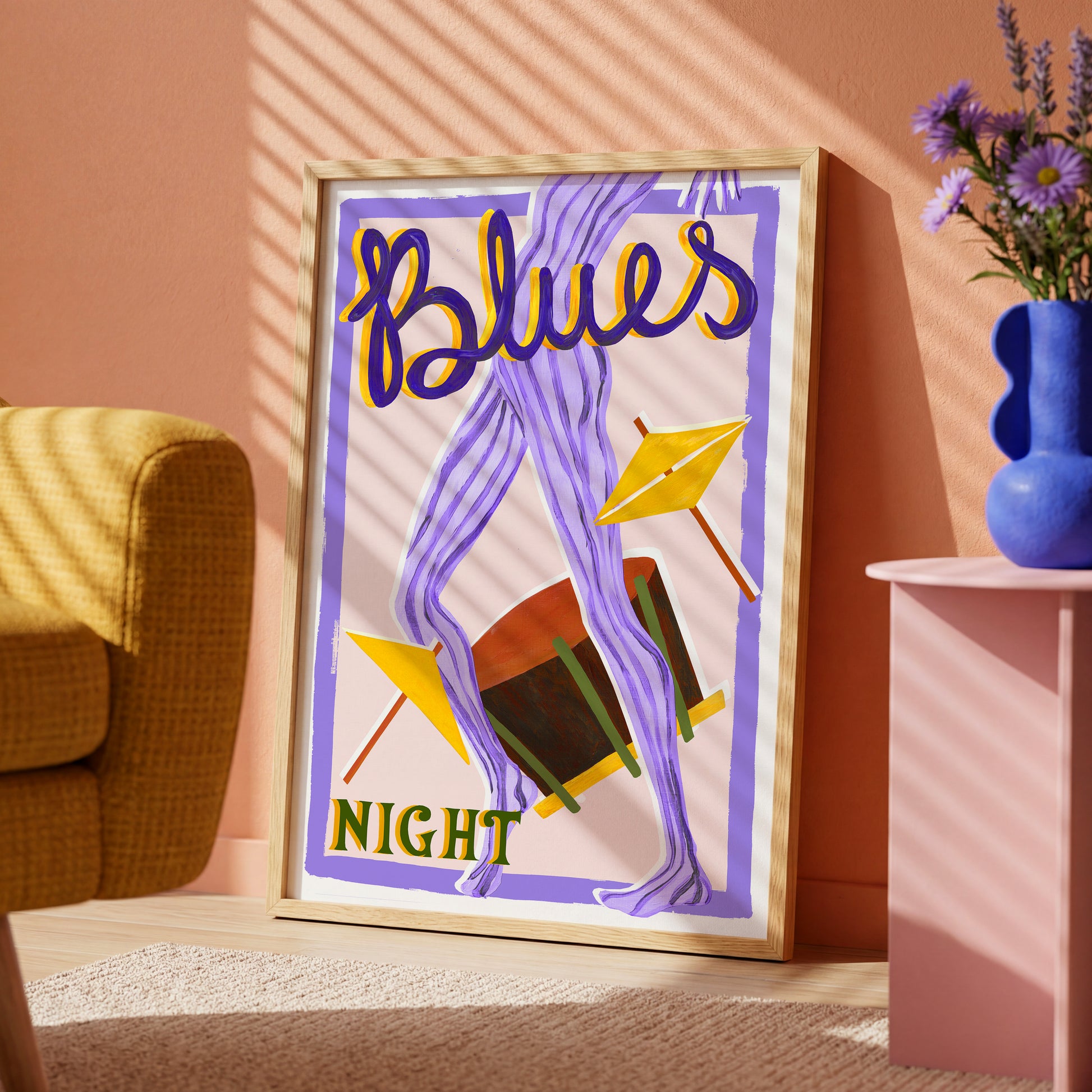 Framed artwork with 'Blues Night' text in a room with a couch and vase.