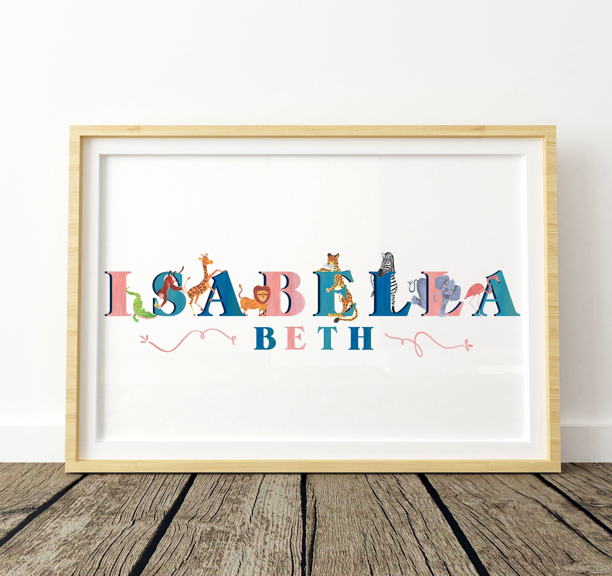 Framed artwork with colorful letters spelling 'Isabella Beth' on a white background