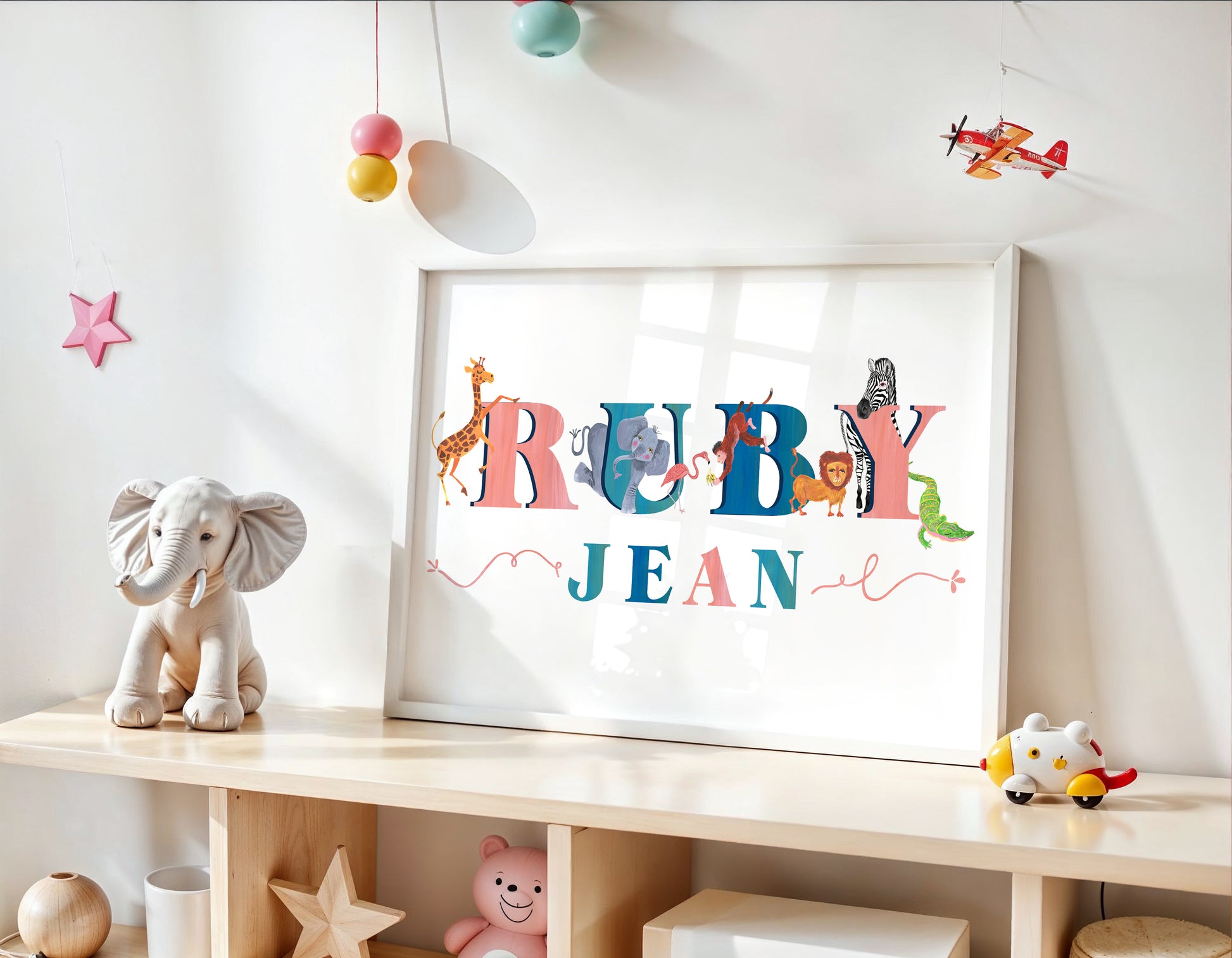 Children's room with a name sign reading 'RUBY JEAN' on a shelf.