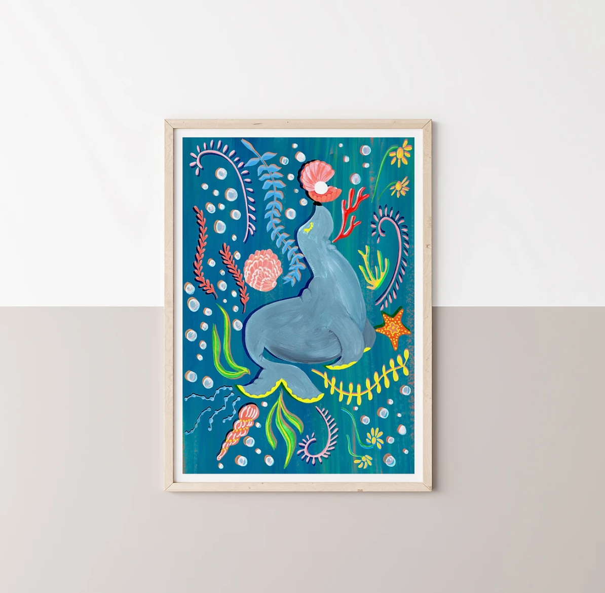 Framed artwork of a Sea Lion surrounded by sea plants and fish on a blue background.