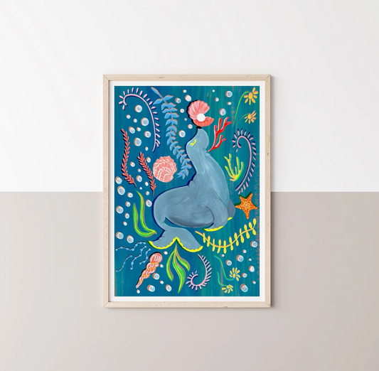 Framed artwork of a Sea Lion surrounded by sea plants and fish on a blue background.