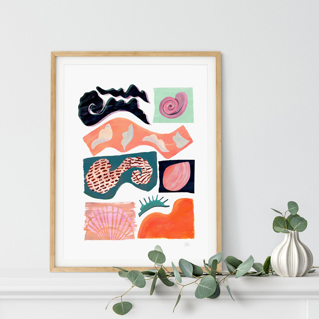 Framed abstract art print with colorful shapes on a white wall.