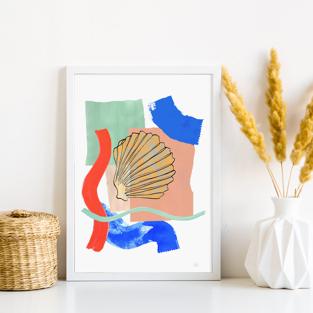 Framed abstract art print with colorful shapes and a shell on a white wall.