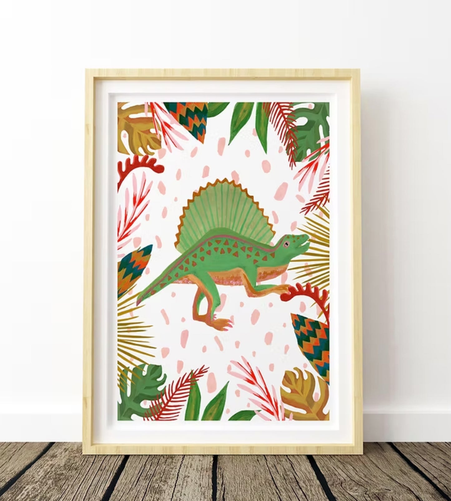Framed artwork with a green dinosaur and colorful leaves on a white background