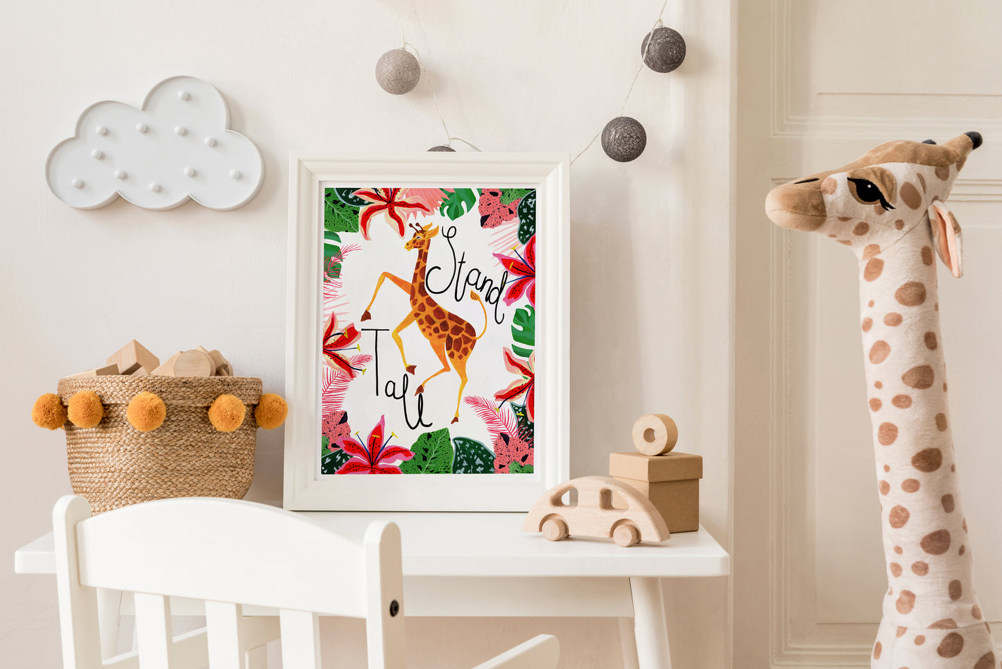 Decorative print with a giraffe and floral design on a shelf in a child's room.