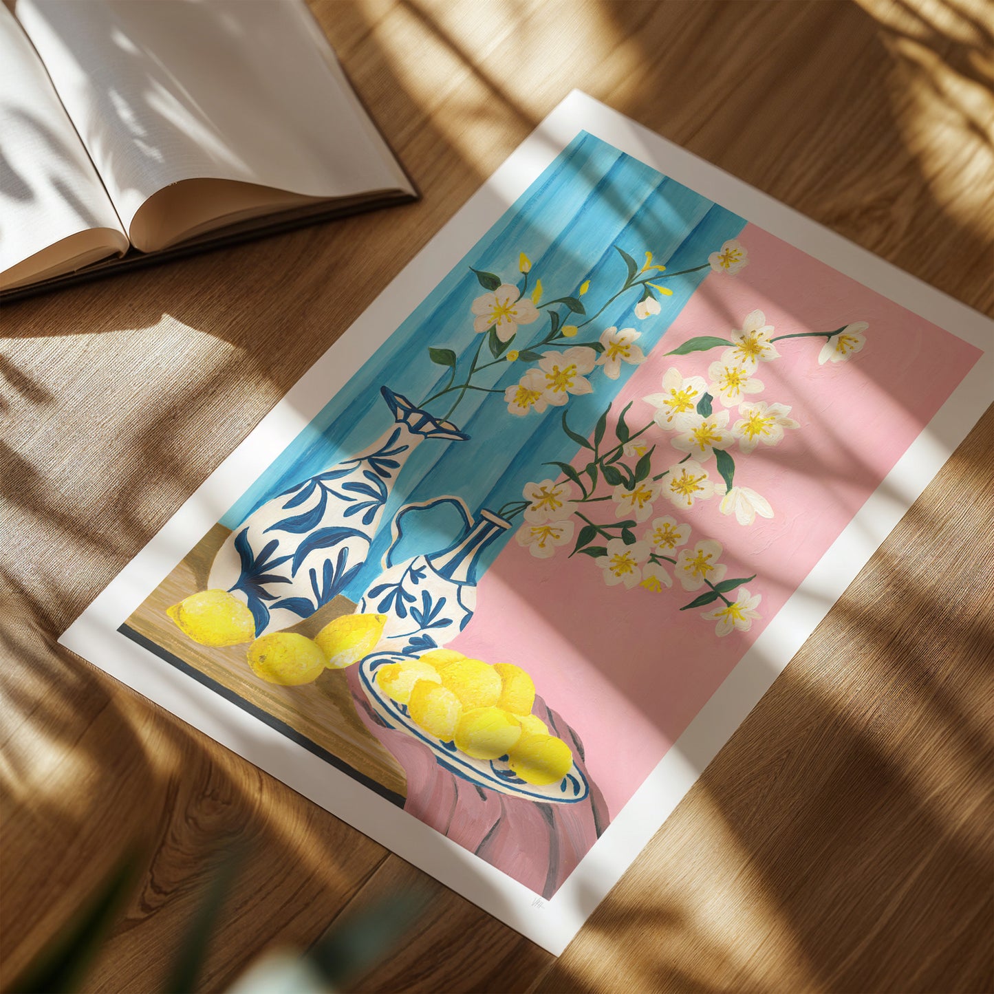 Framed artwork with floral and lemon design on a wooden surface