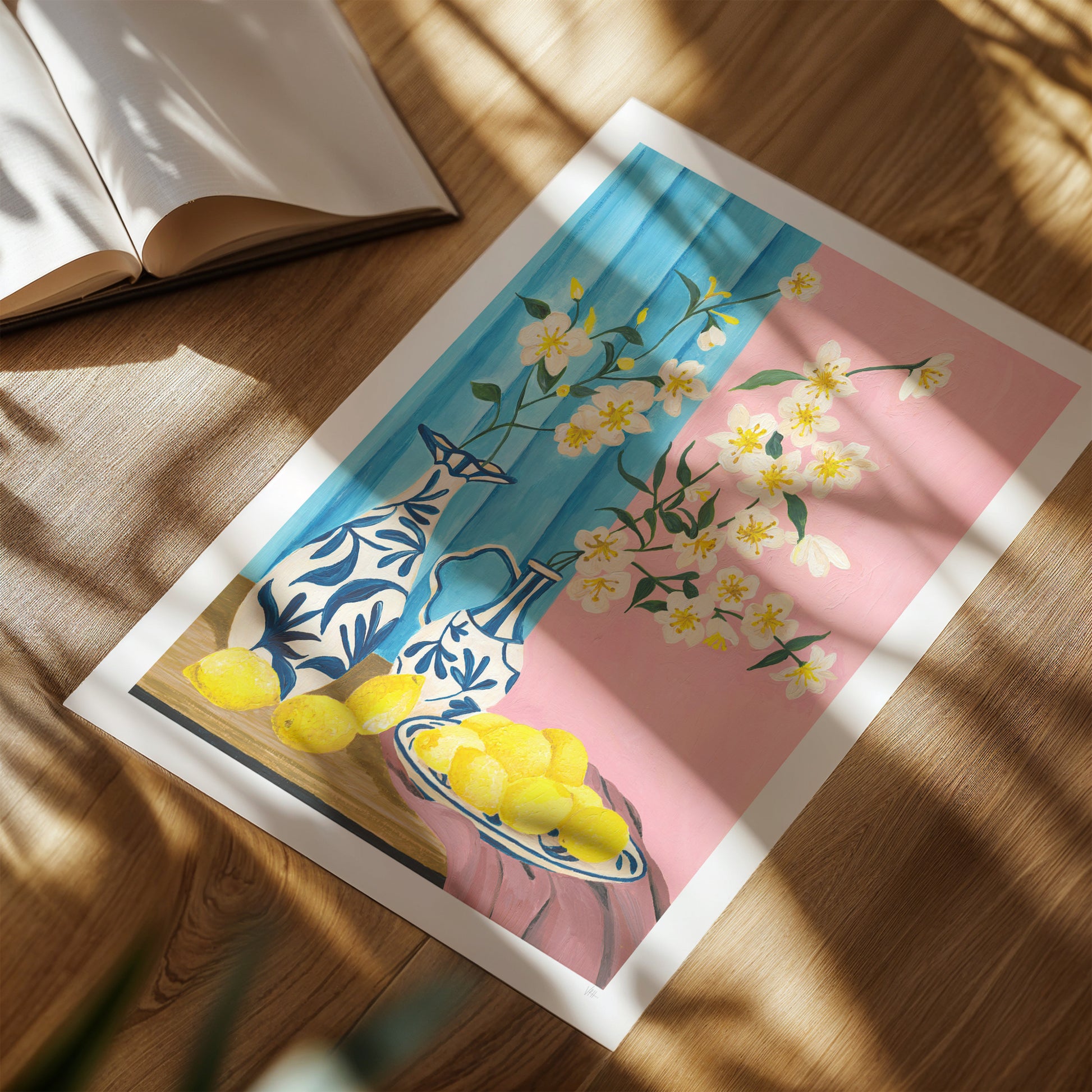 Framed artwork with floral and lemon design on a wooden surface