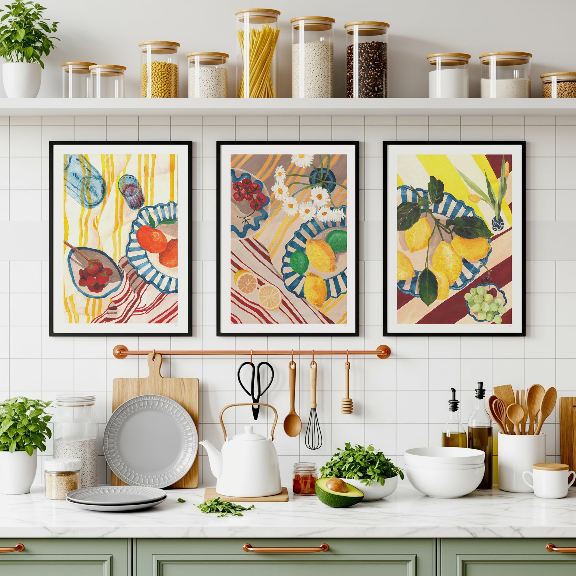 Modern green and white kitchen with copper hardware, with a still life food set of 3 prints on the wall