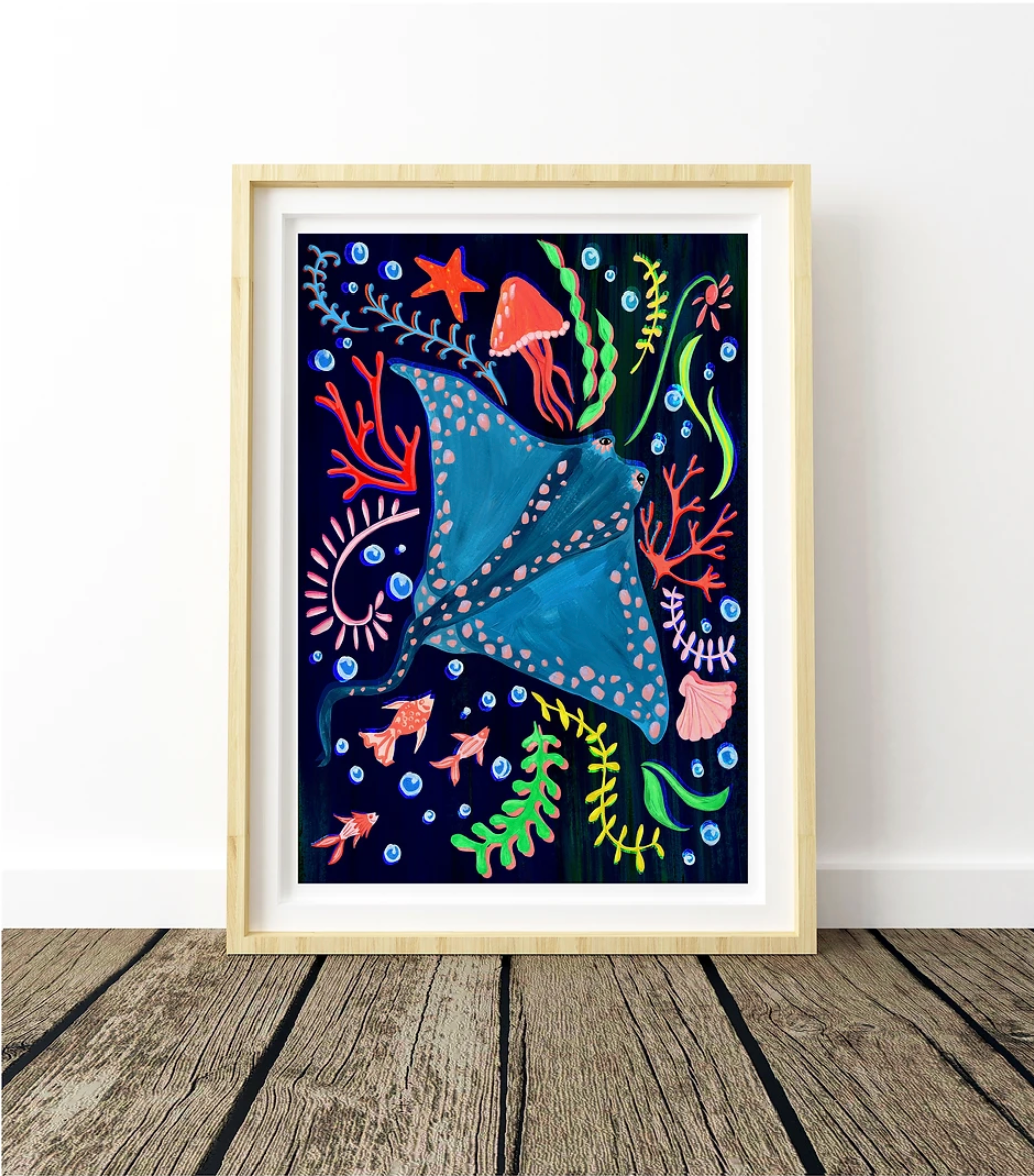 Framed artwork of a blue stingray with colorful marine life on a white wall.