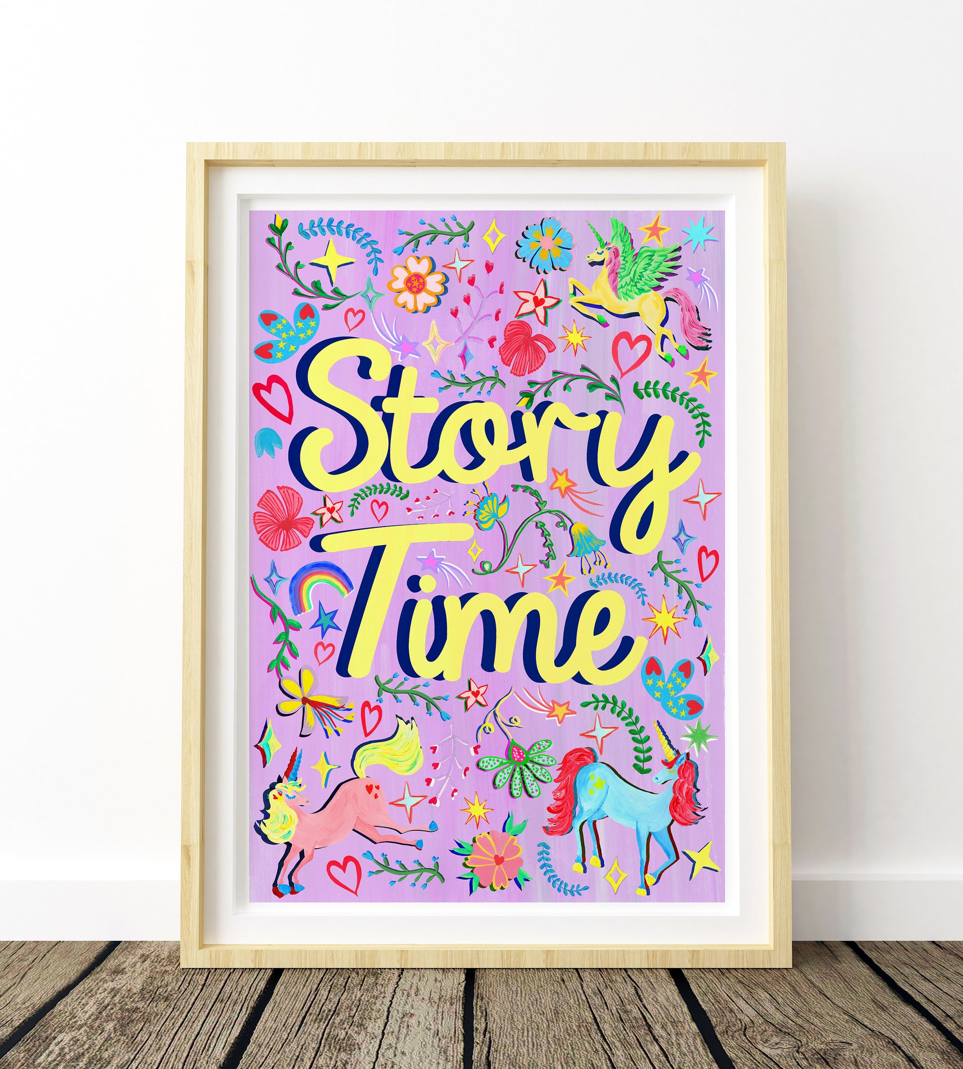 Framed colorful artwork with 'Story Time' text on a wooden floor.