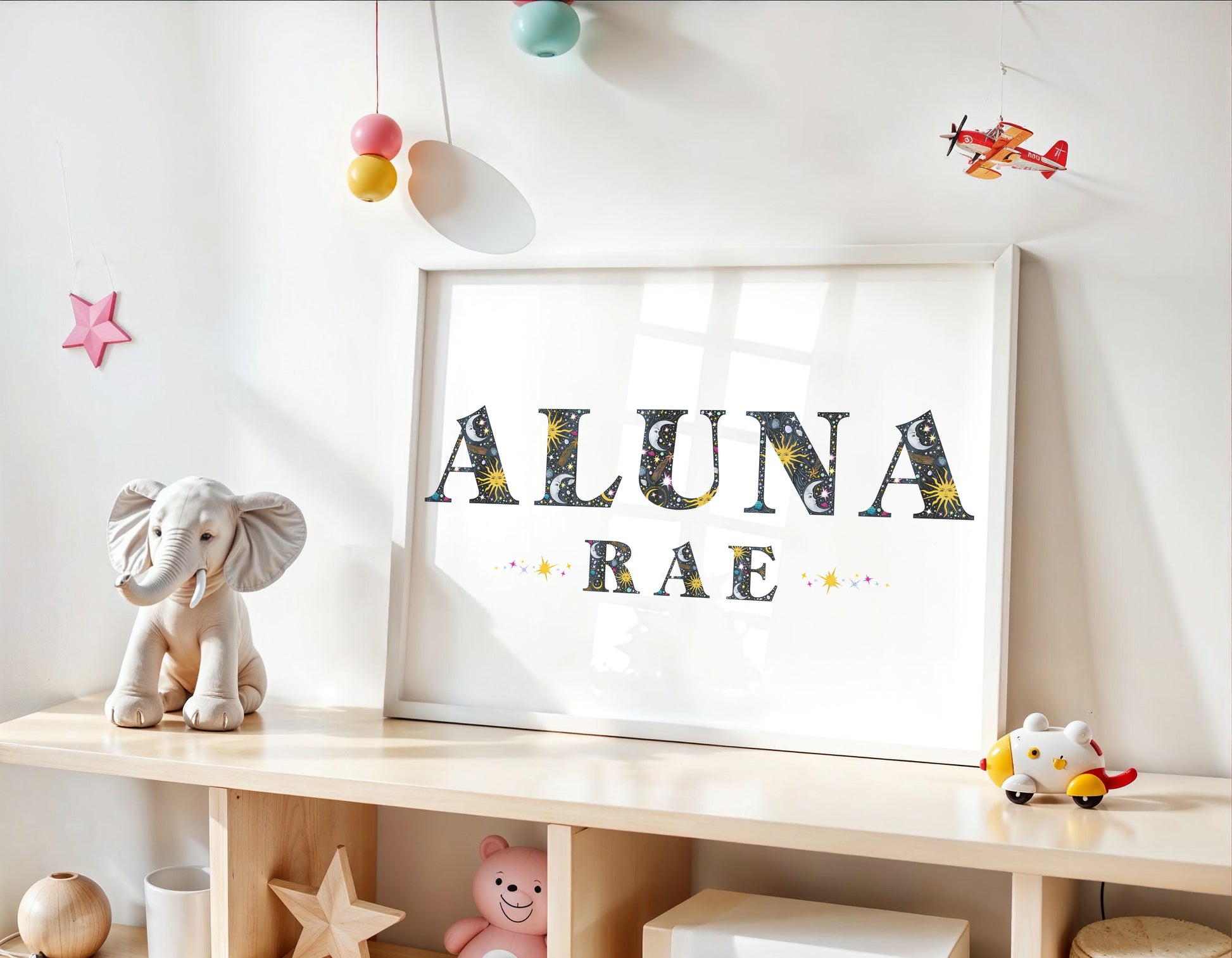 Children's room with a shelf displaying toys and a name sign with sun, moon and star illustrations