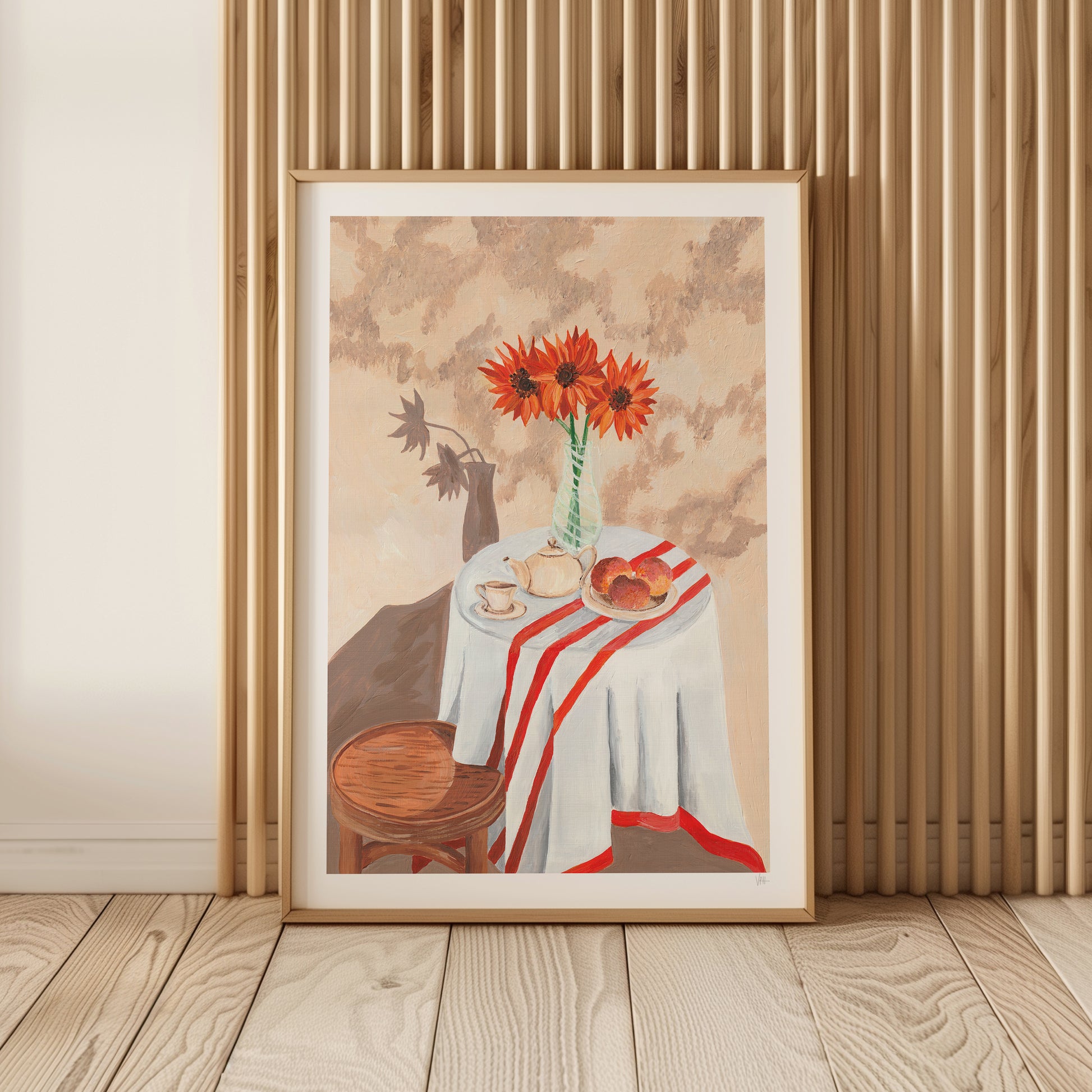 Framed artwork of a still life scene with flowers and table setting on a wooden floor.