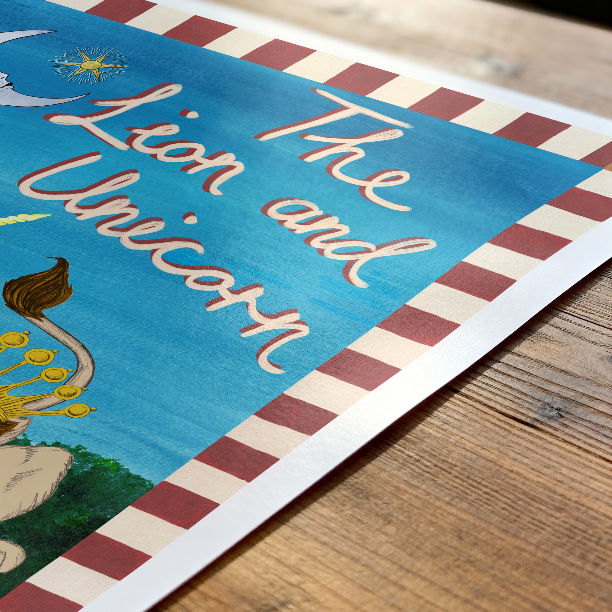 Poster of 'The Lion and the Unicorn' with decorative border on a wooden surface