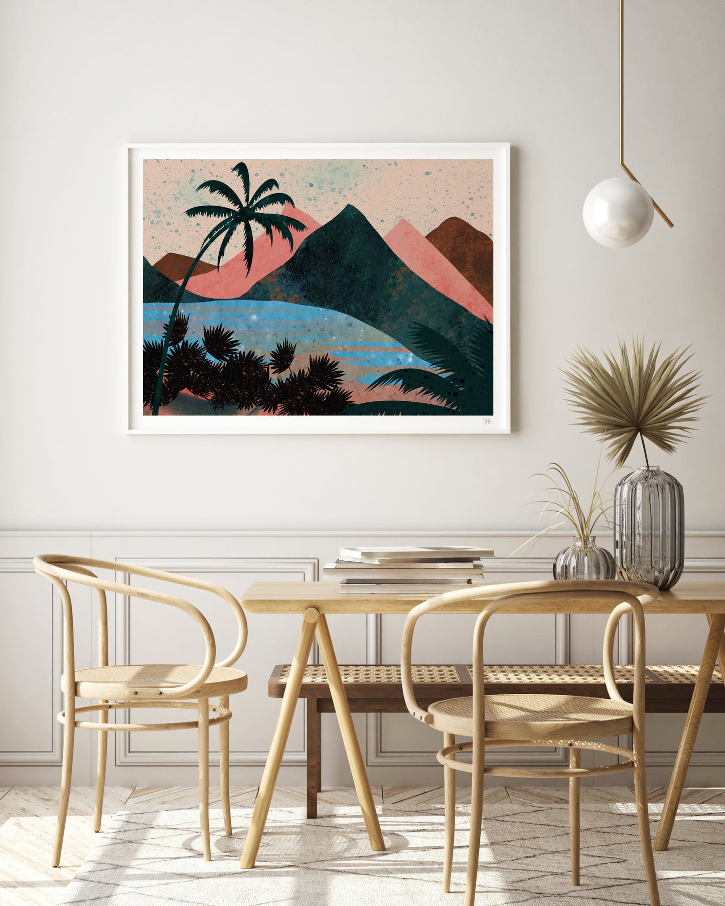 Dining room with a table and chairs, featuring a framed artwork of a tropical landscape on the wall.