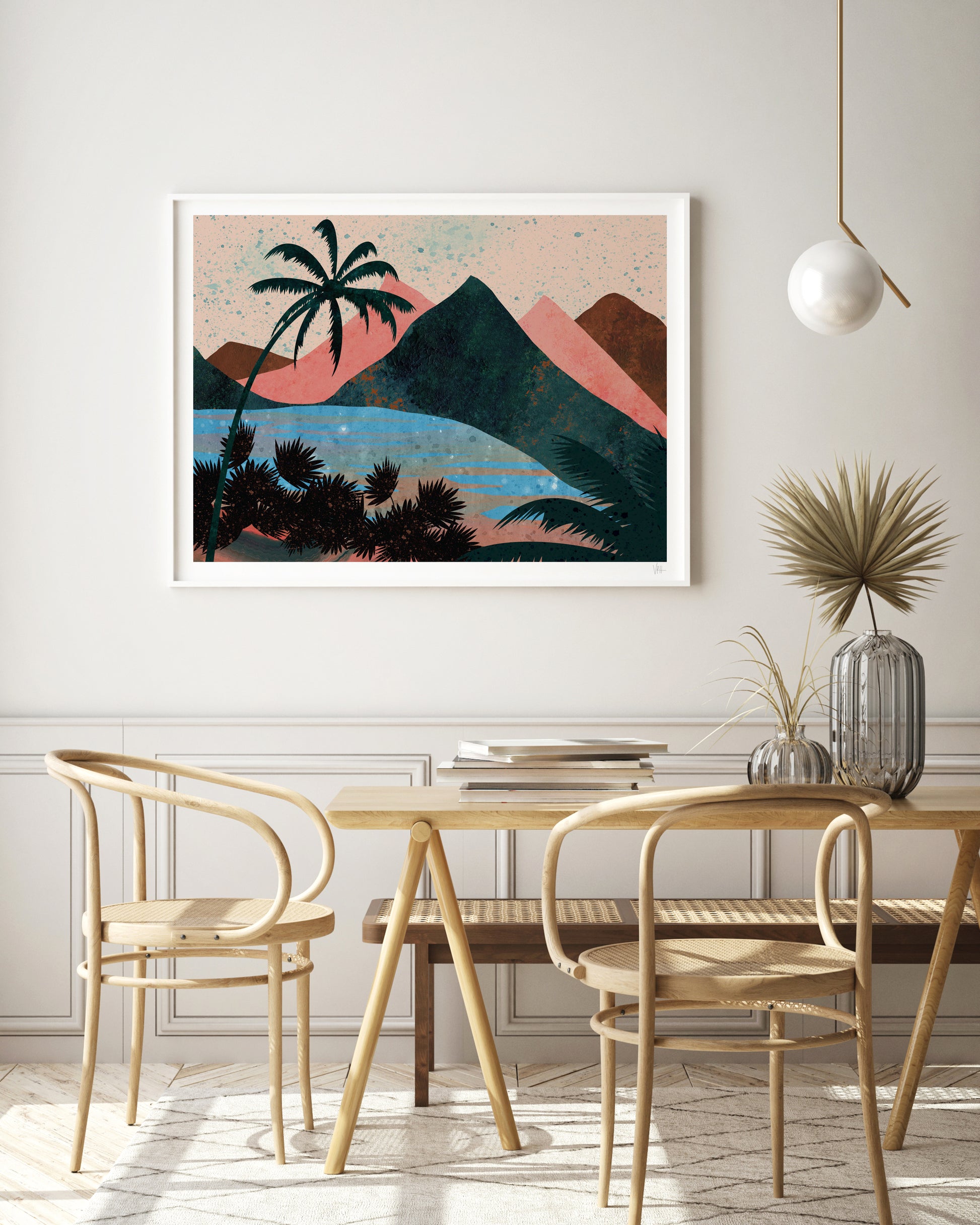 Dining room with a table and chairs, featuring a framed artwork of a tropical landscape on the wall.