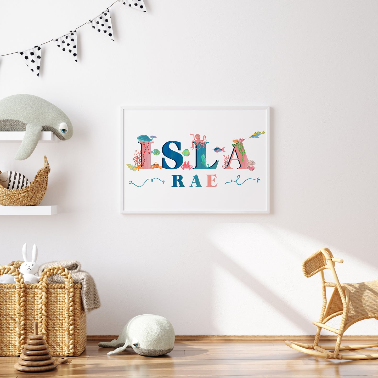 Framed children's name art with  sea animal illustrations with toys and decor in a room.