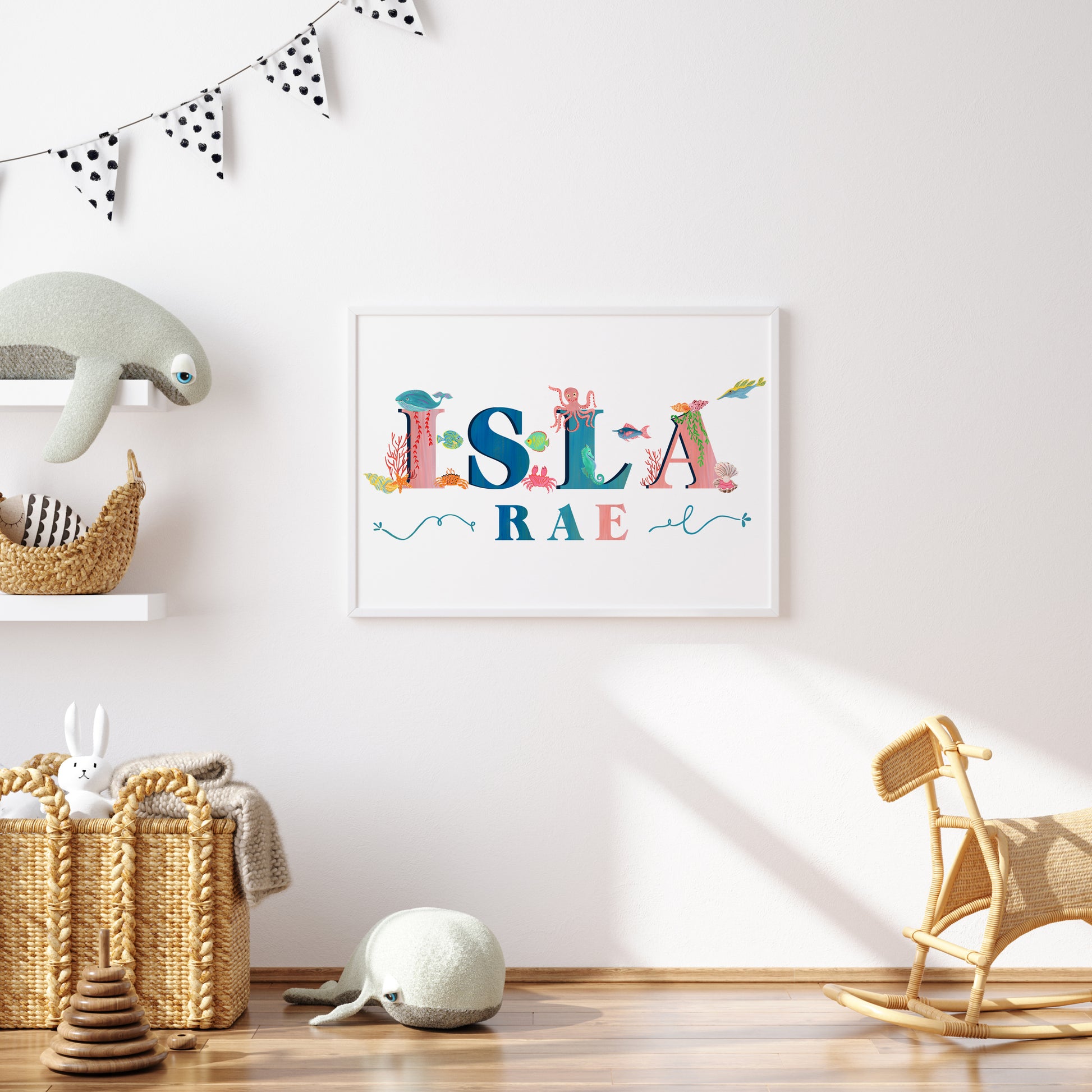 Framed children's name art with  sea animal illustrations with toys and decor in a room.