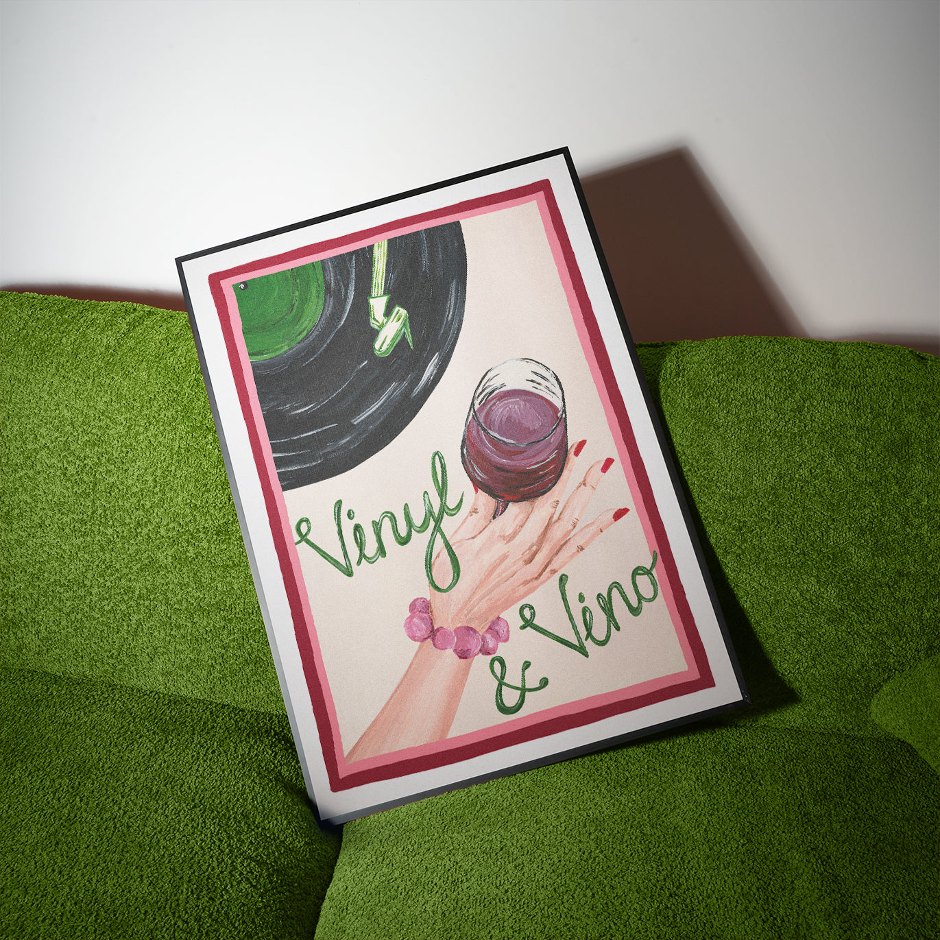 Card with vinyl record and wine glass illustration on a green surface