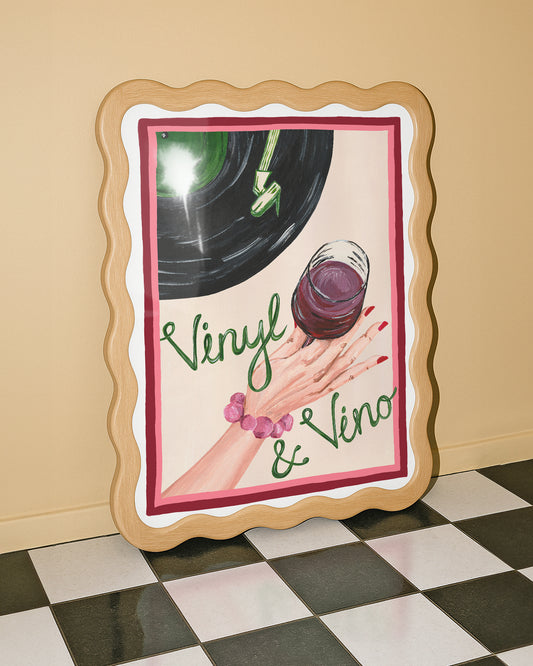 Decorative sign with 'Vinyl & Vino' text, a record, and a glass of red wine on a checkered floor.
