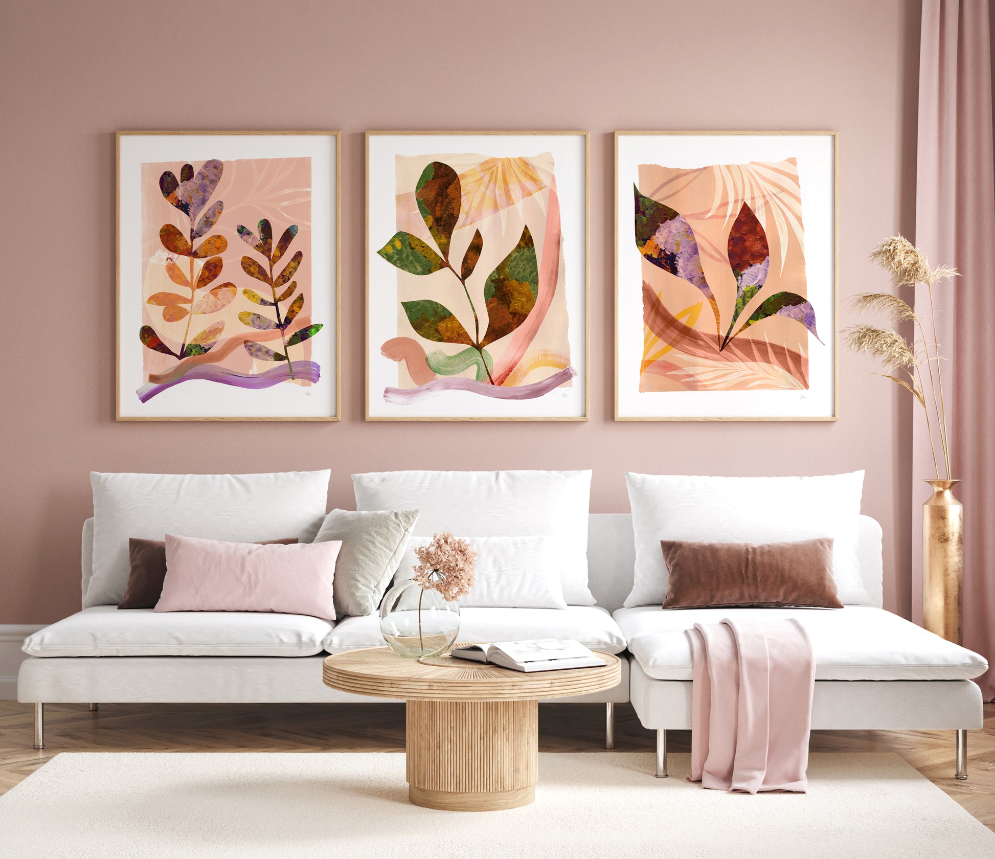 Living room with a white sofa, decorative pillows, and three abstract leaf prints on the wall.