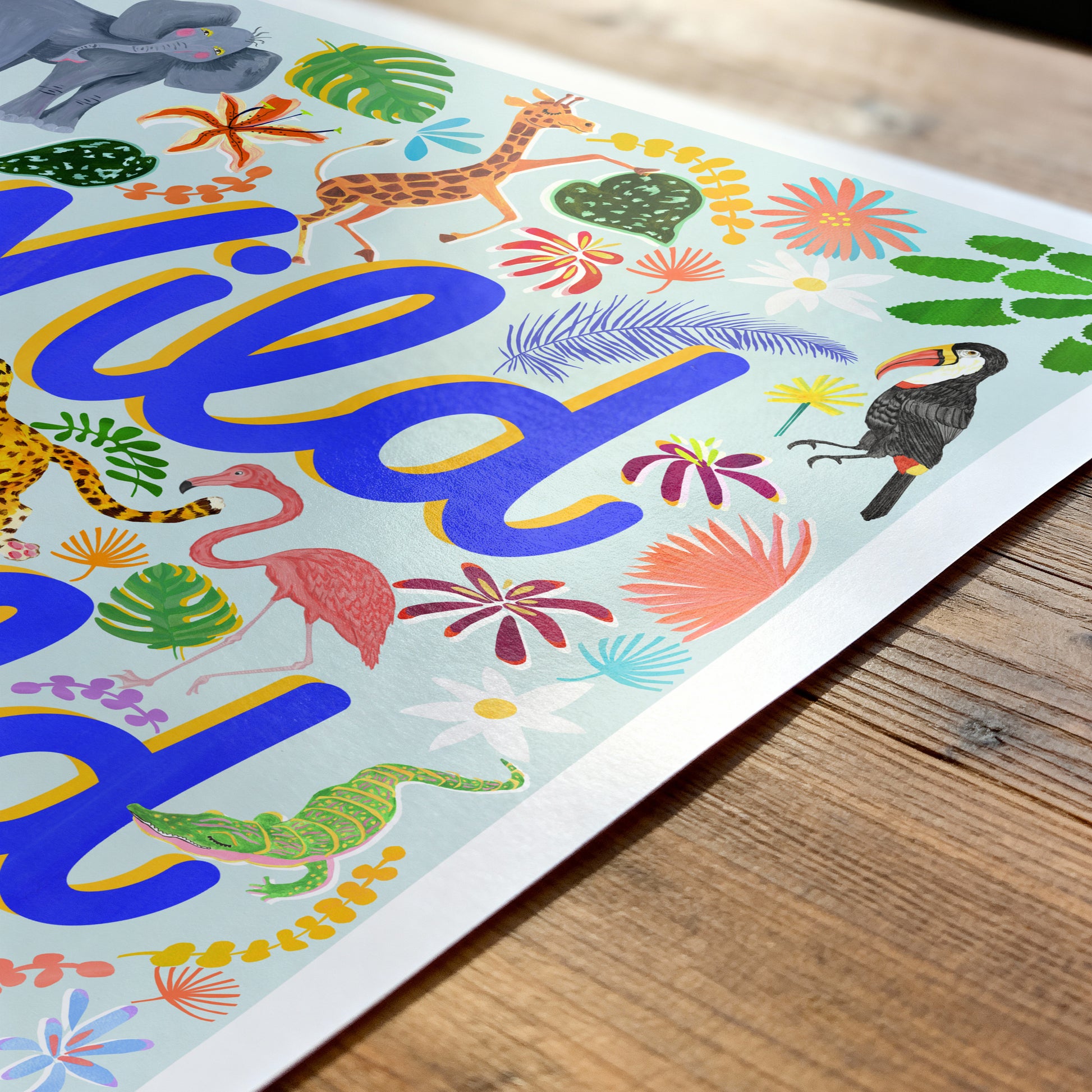 Colorful children's poster with animals and the word 'Wild' on a wooden surface