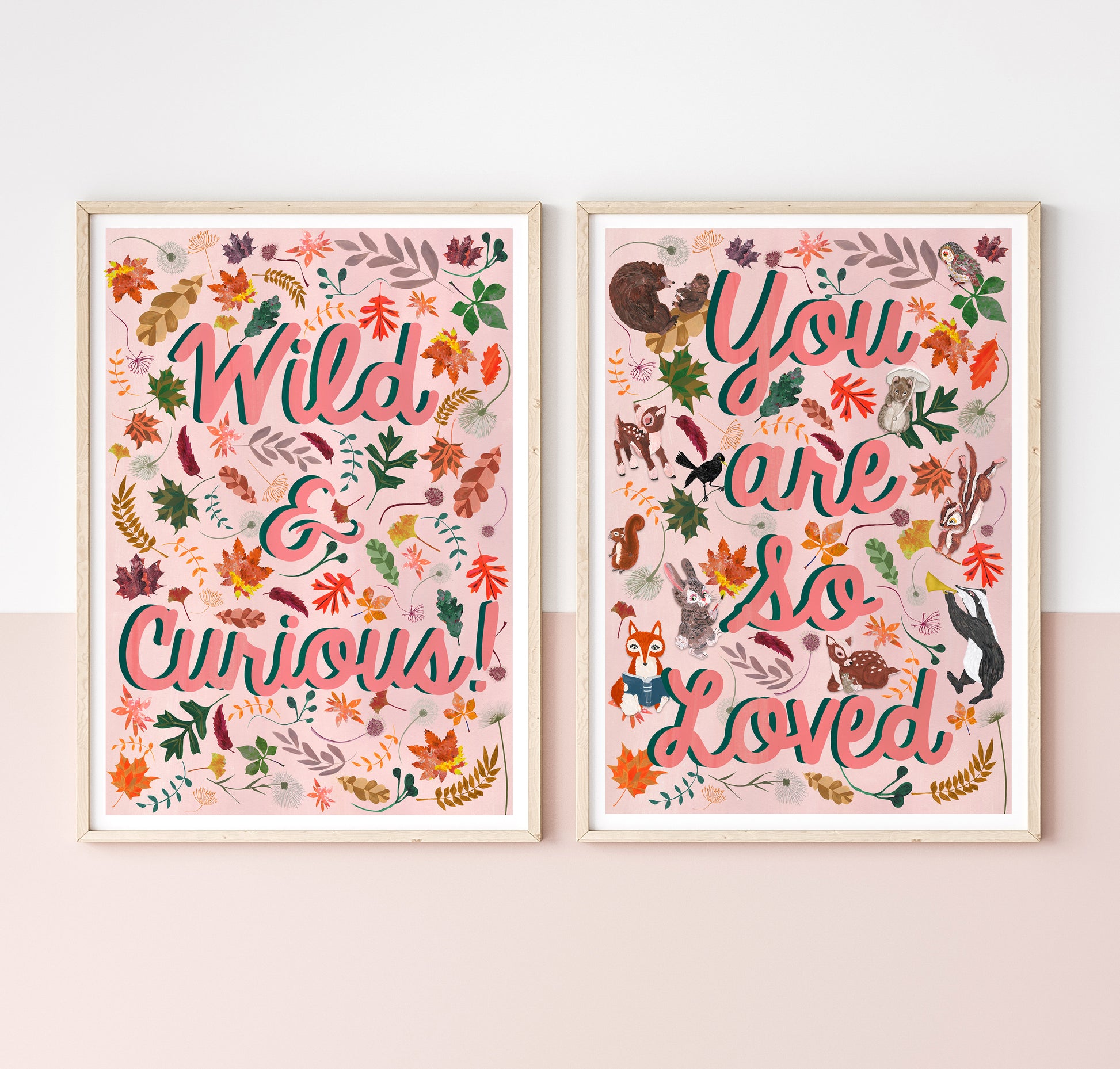 Two framed prints with floral and animal designs on a light pink wall.