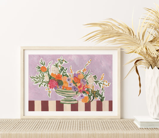 Framed floral artwork on a table with decorative elements