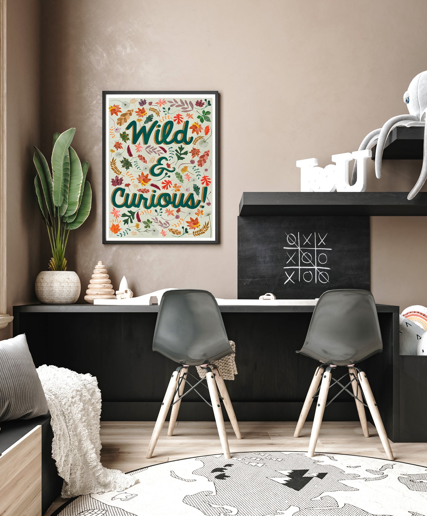 Modern interior with 'Wild & Curious' poster, black chairs, and decorative items.