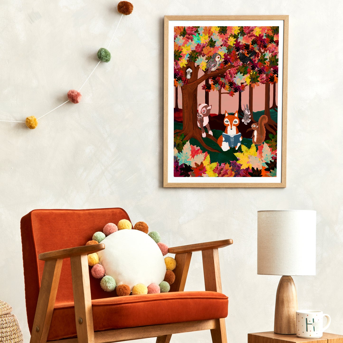 Colorful children's illustration framed on a wall above an orange chair with decorative elements.