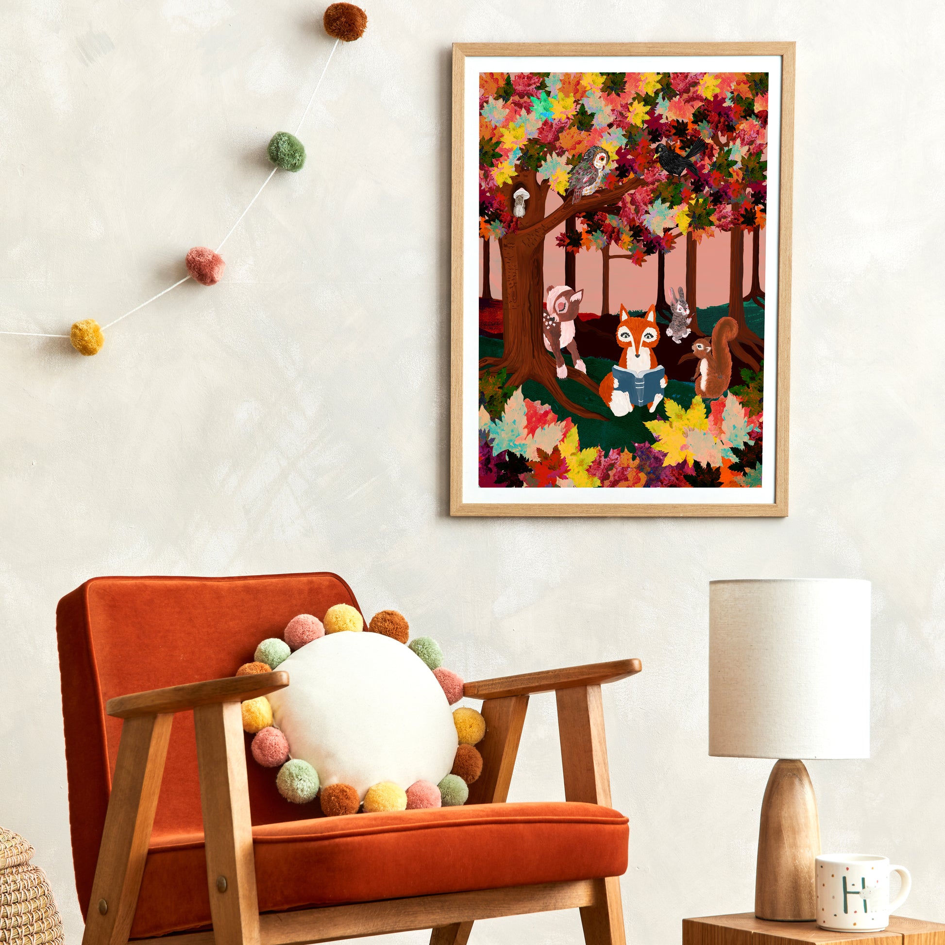 Colorful children's illustration framed on a wall above an orange chair with decorative elements.