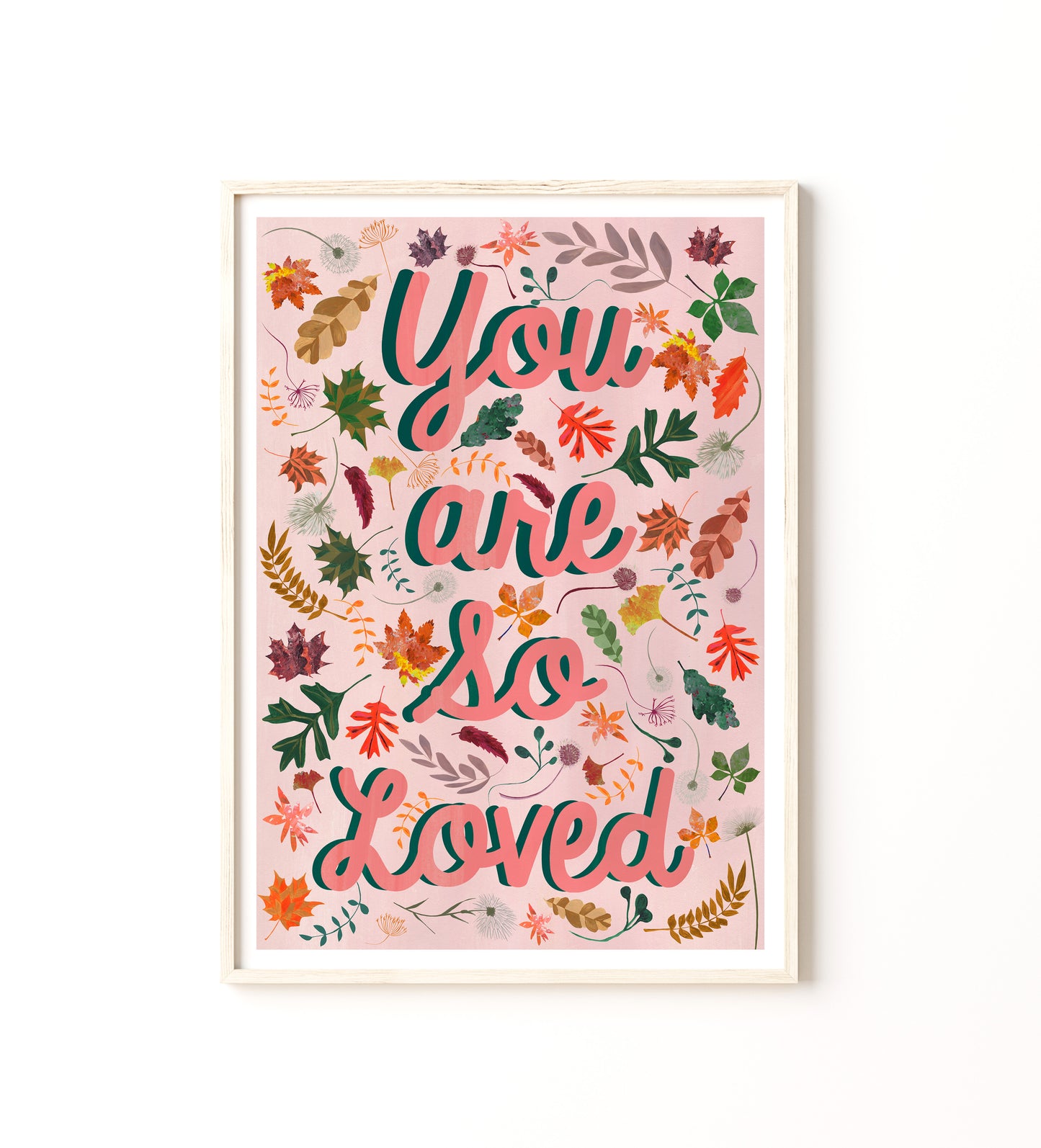 Framed artwork with 'You are so loved' text and autumn leaf designs on a white background