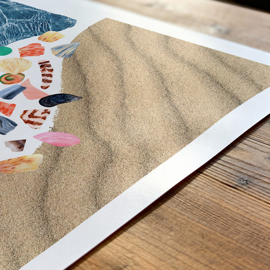 Close-up of a sand texture print with colorful abstract shapes on a wooden surface