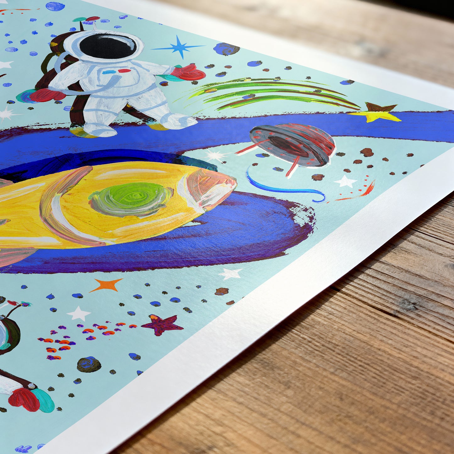 Colorful children's illustration of an astronaut and space-themed elements on a wooden surface.