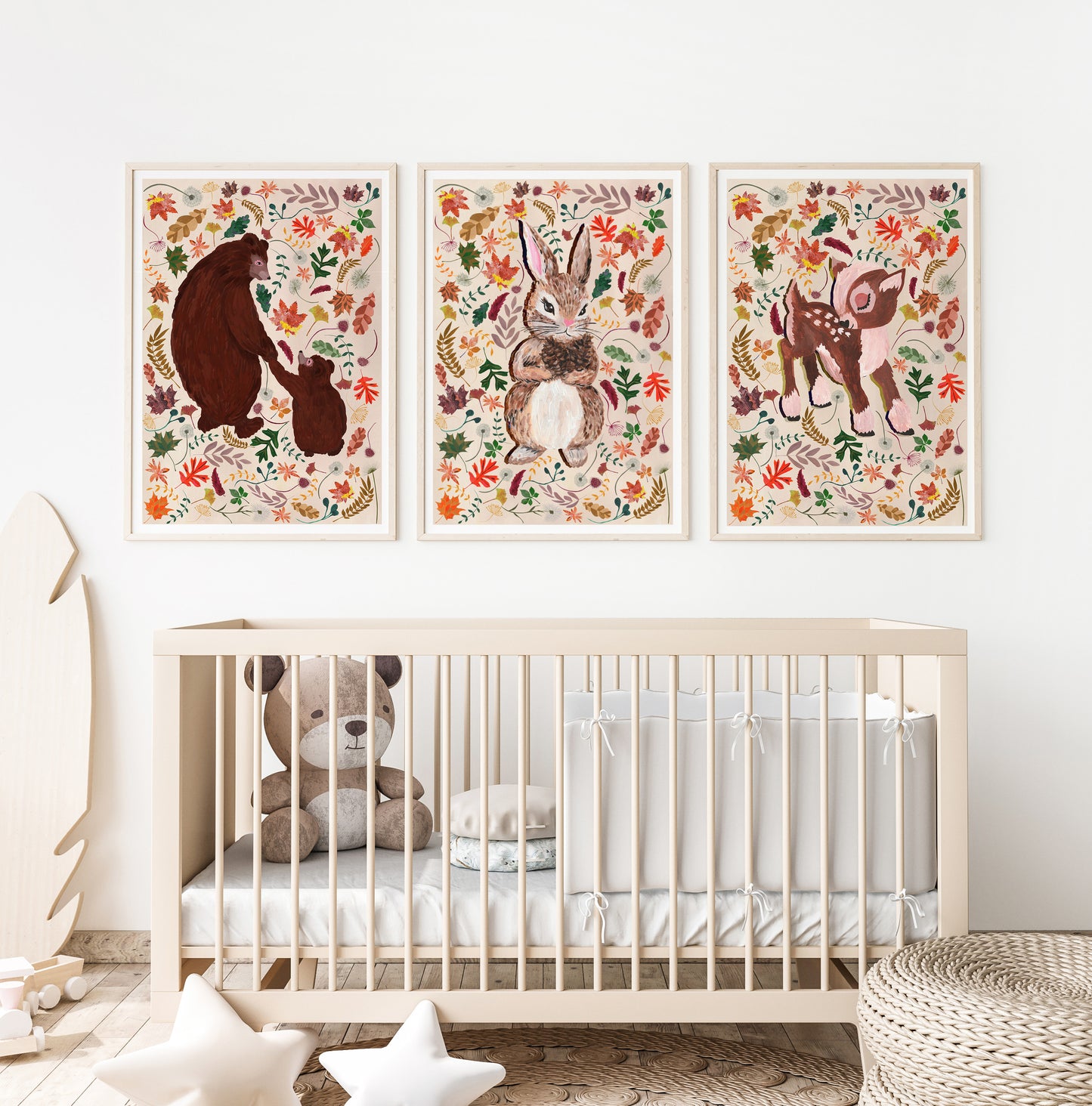 Nursery room with a crib and wall art featuring animals and flowers.