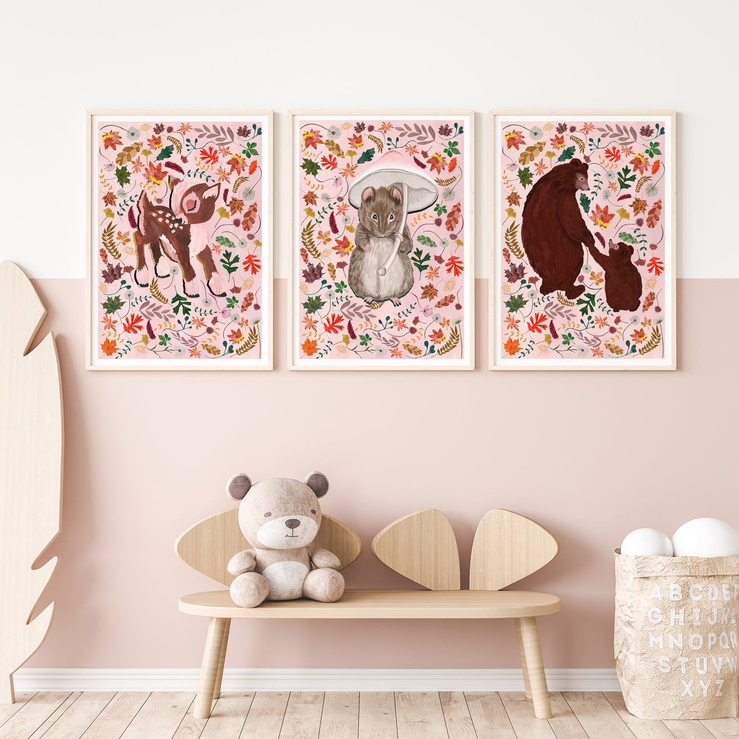 Three framed animal illustrations on a wall above a wooden bench with a teddy bear.
