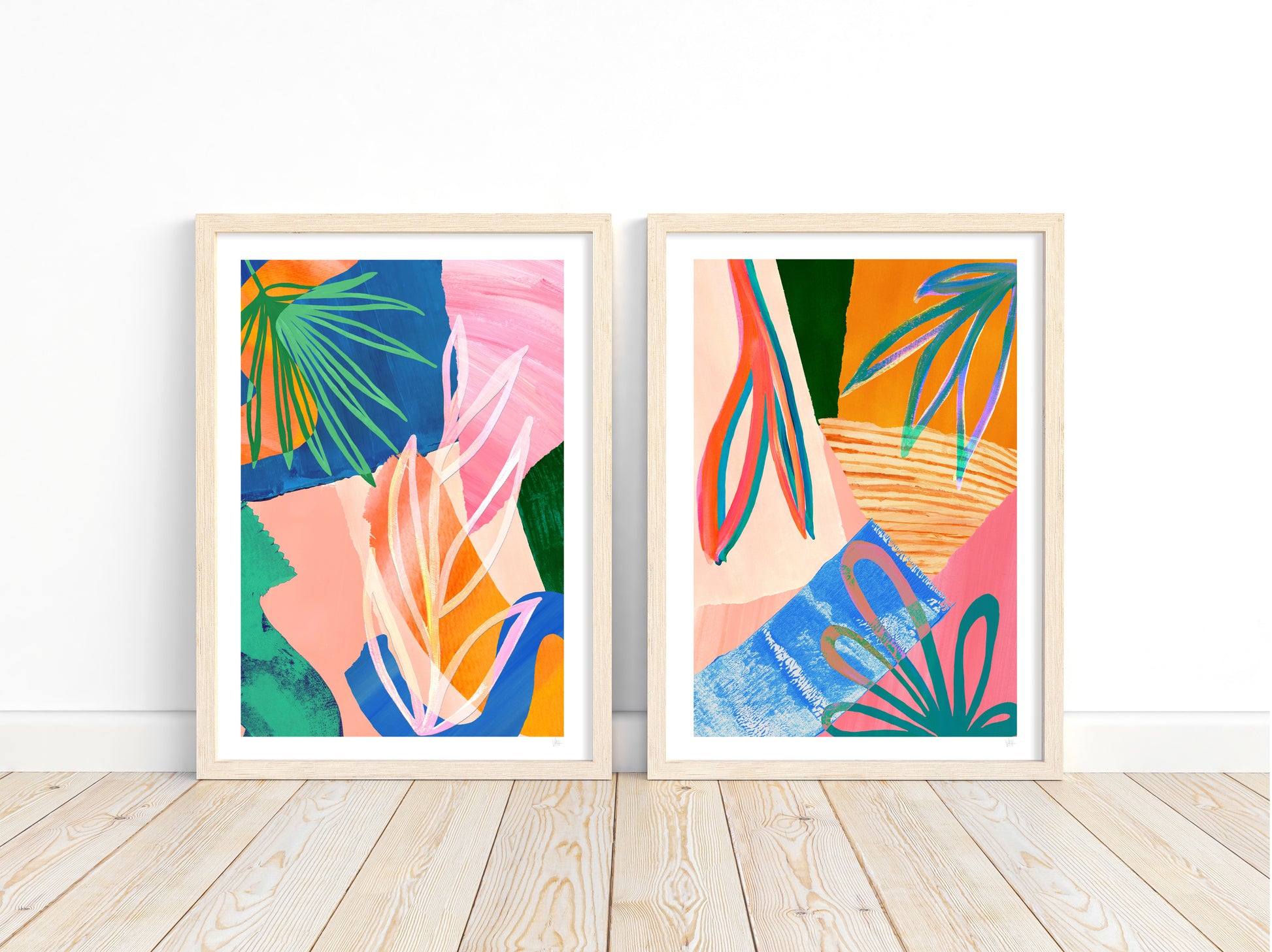Two colorful abstract art prints in wooden frames on a white wall.