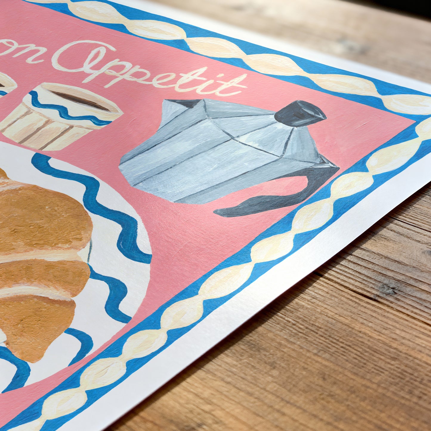 Illustration of a teapot and croissant on a colorful background with 'On Appetit' text.