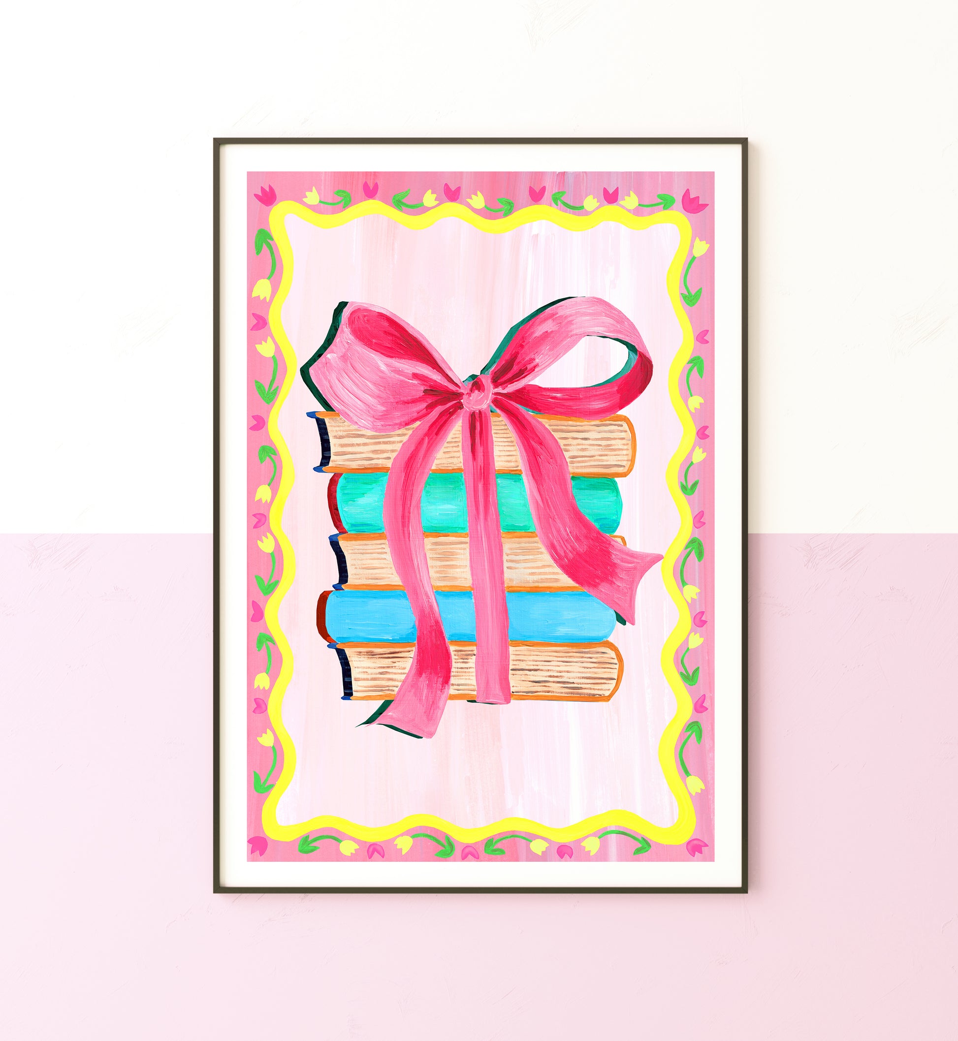 Framed artwork of books with a pink ribbon on a pink background