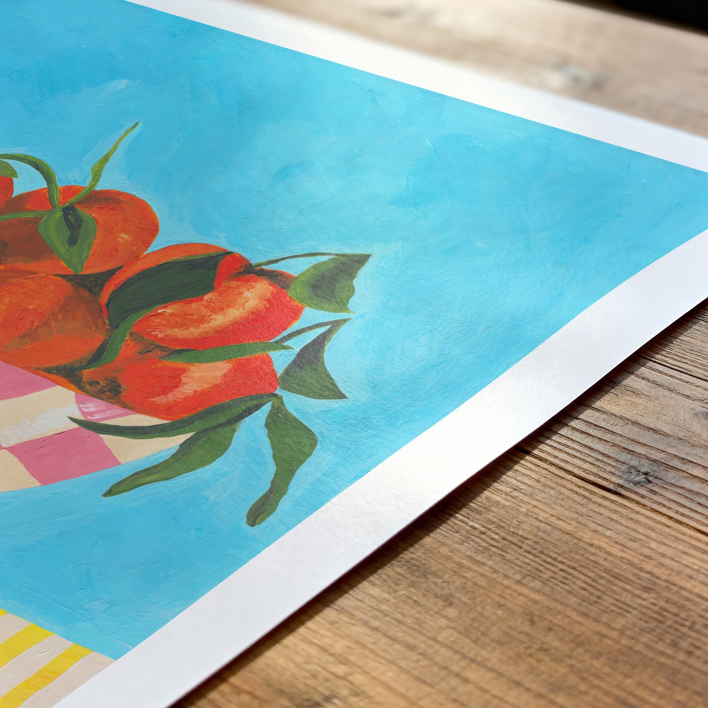 Colorful artwork of oranges on a wooden surface