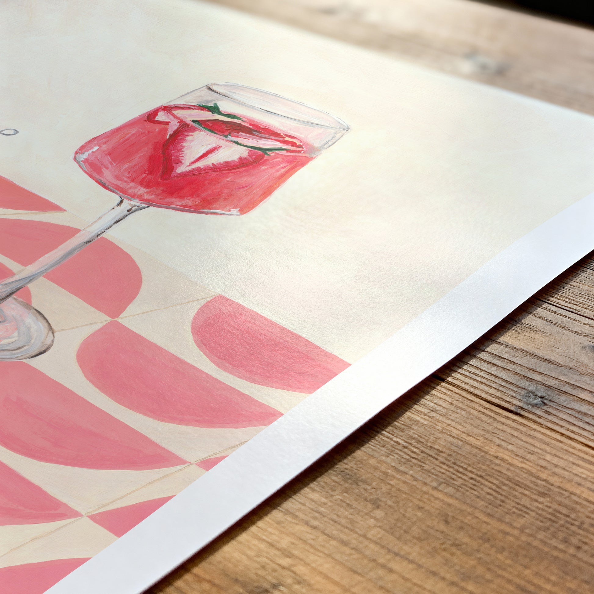 Art print of a pink cocktail glass on a wooden surface