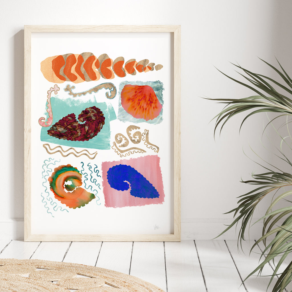 Framed abstract artwork with colorful shapes on a white wall.