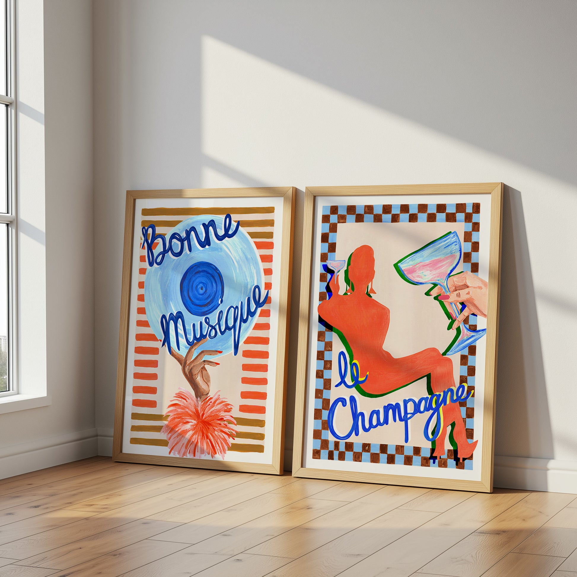 Two framed artworks on a wall with 'Bonne Musique' and 'Le Champagne' text.
