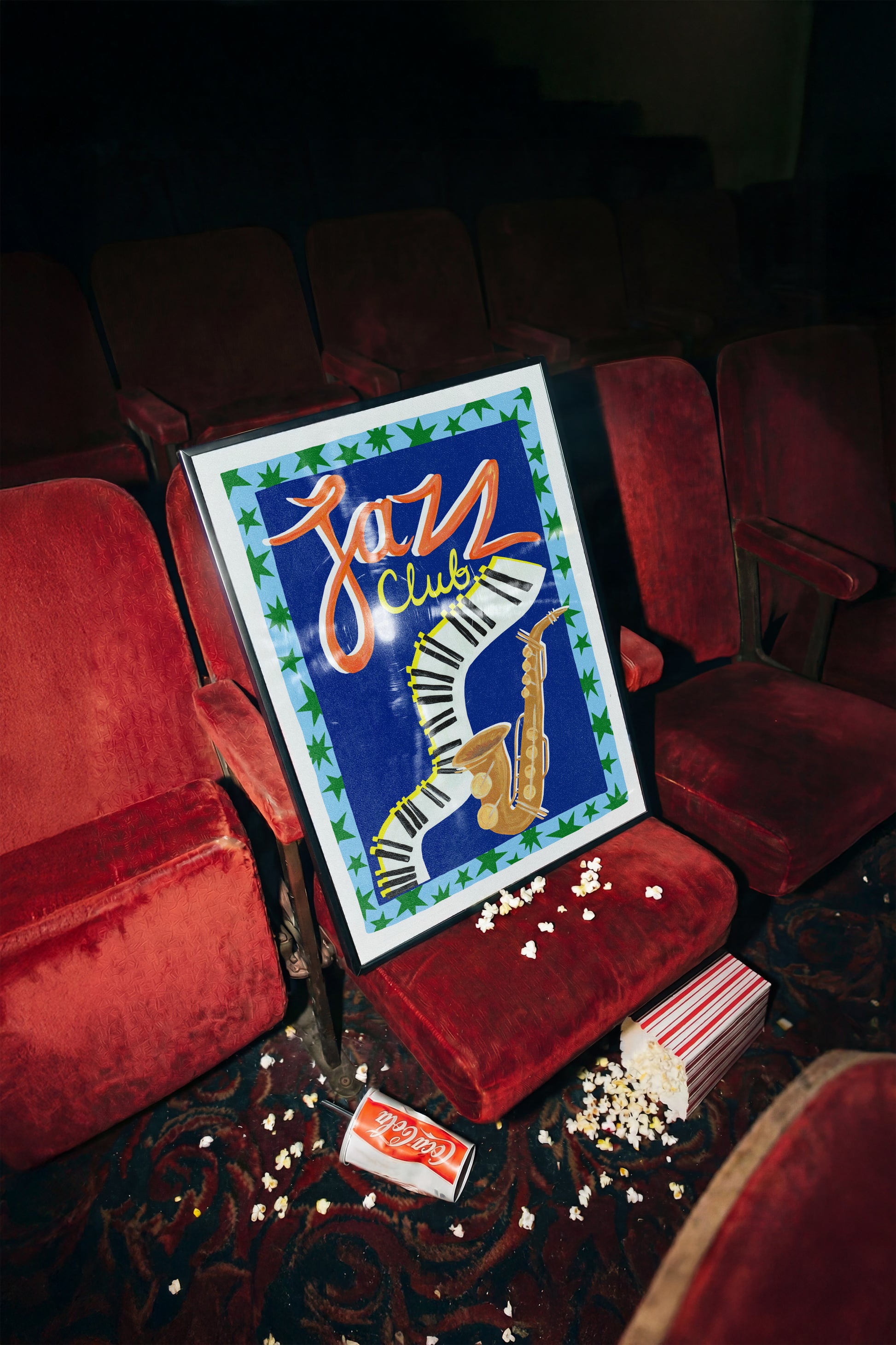 Jazz Club sign in a dimly lit room with red chairs and popcorn.