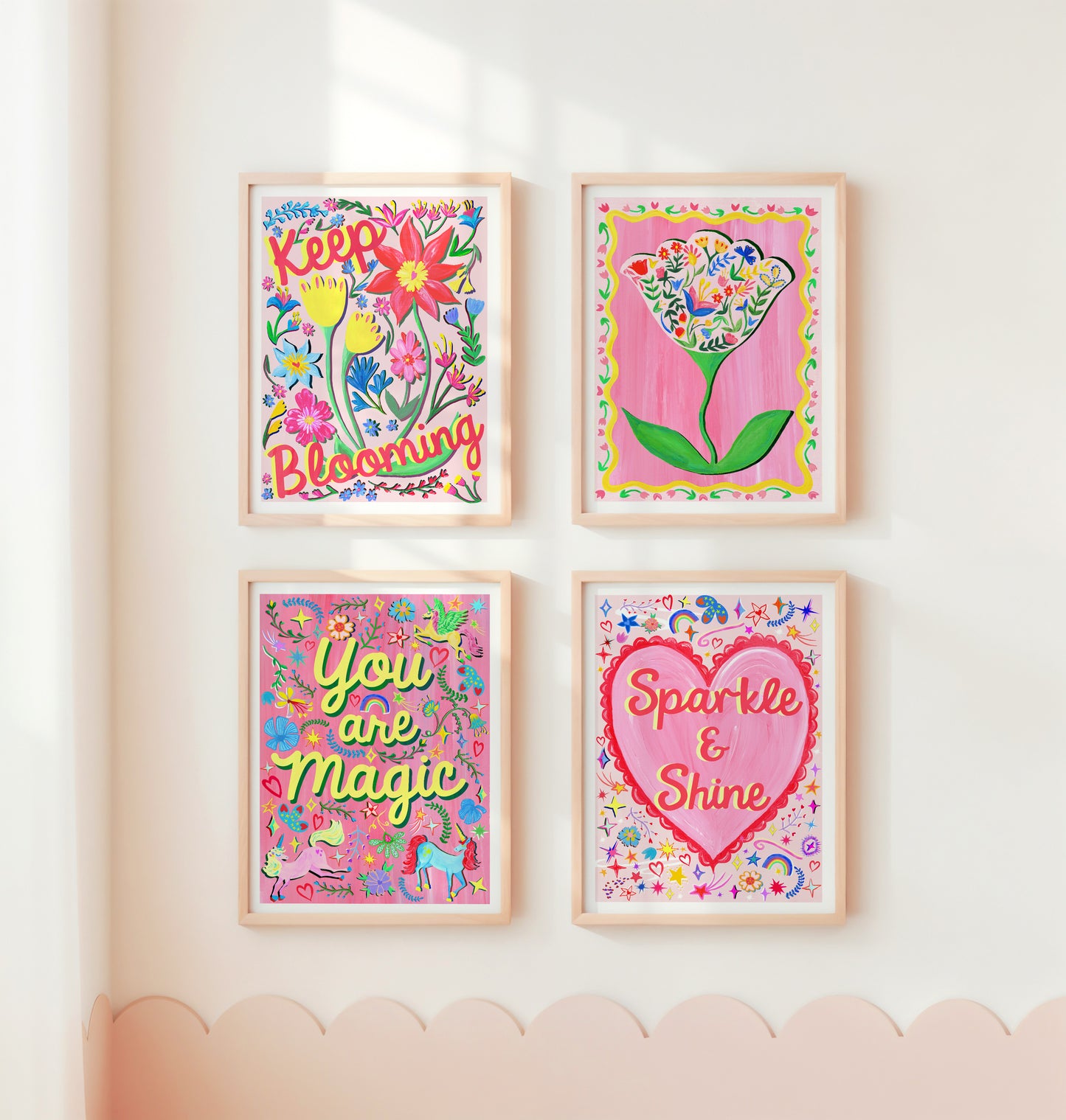 Four colorful framed prints with motivational phrases on a wall.