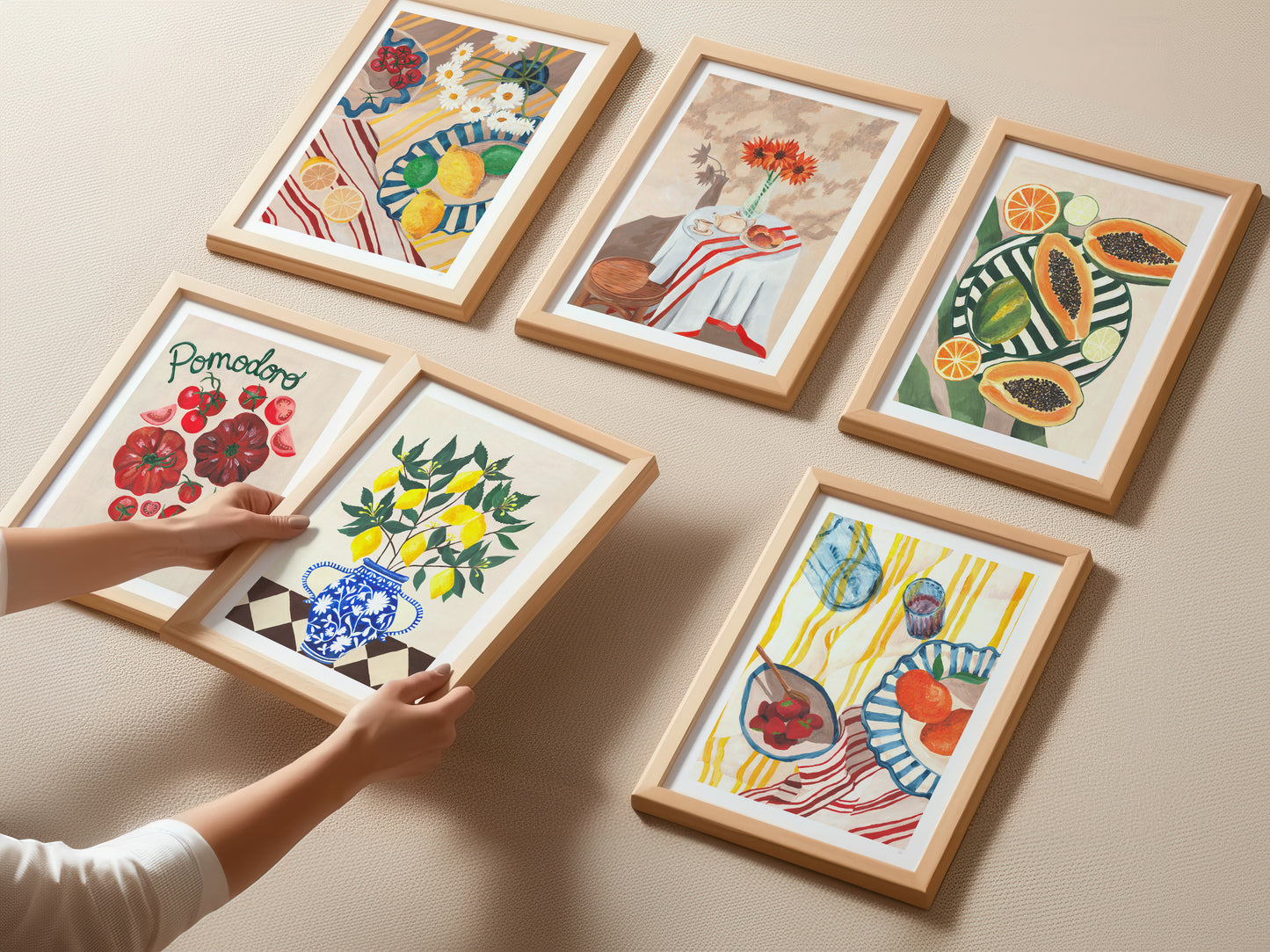 Framed artworks of fruits and vegetables on a beige wall