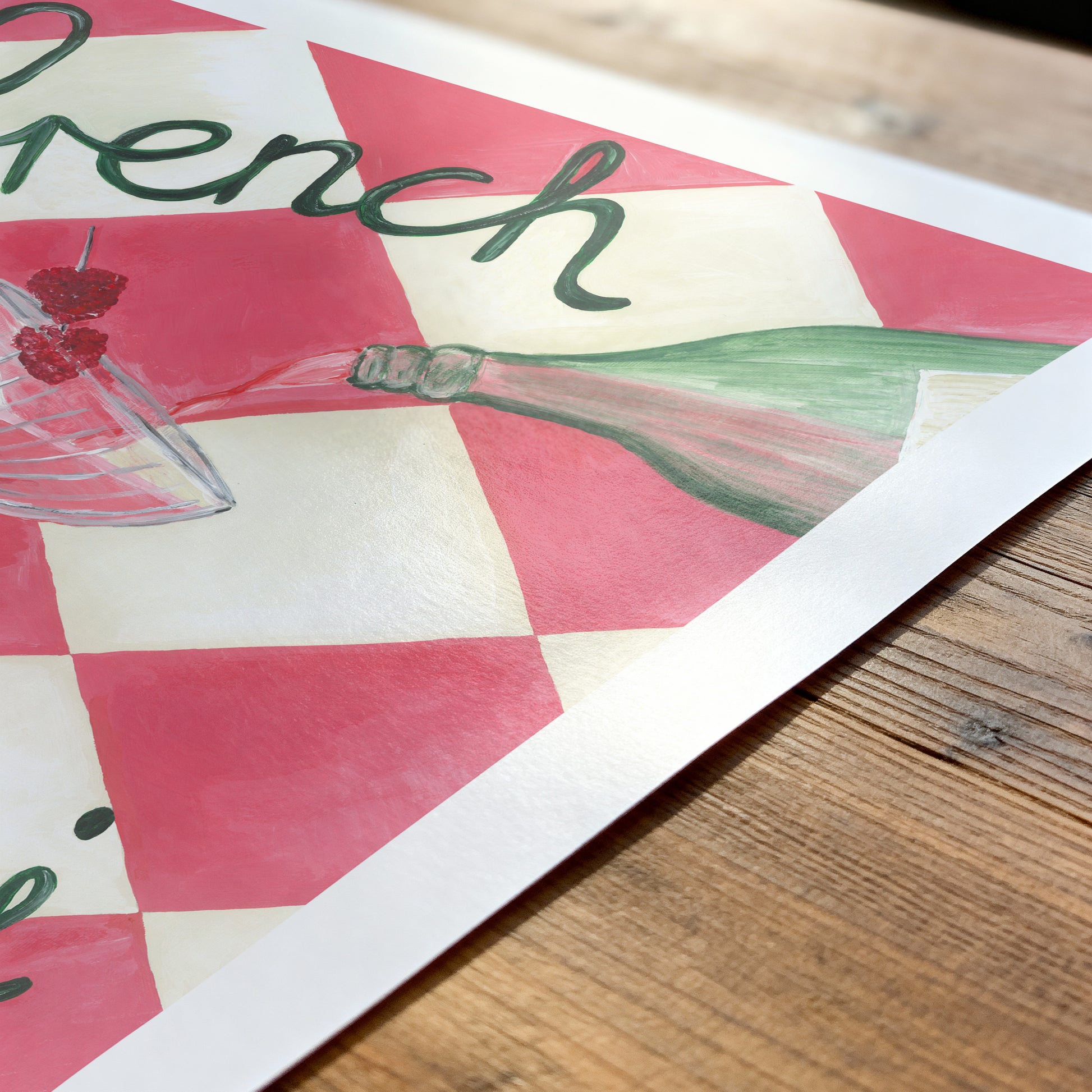 Decorative paper with 'French' text and a cocktail illustration on a wooden surface