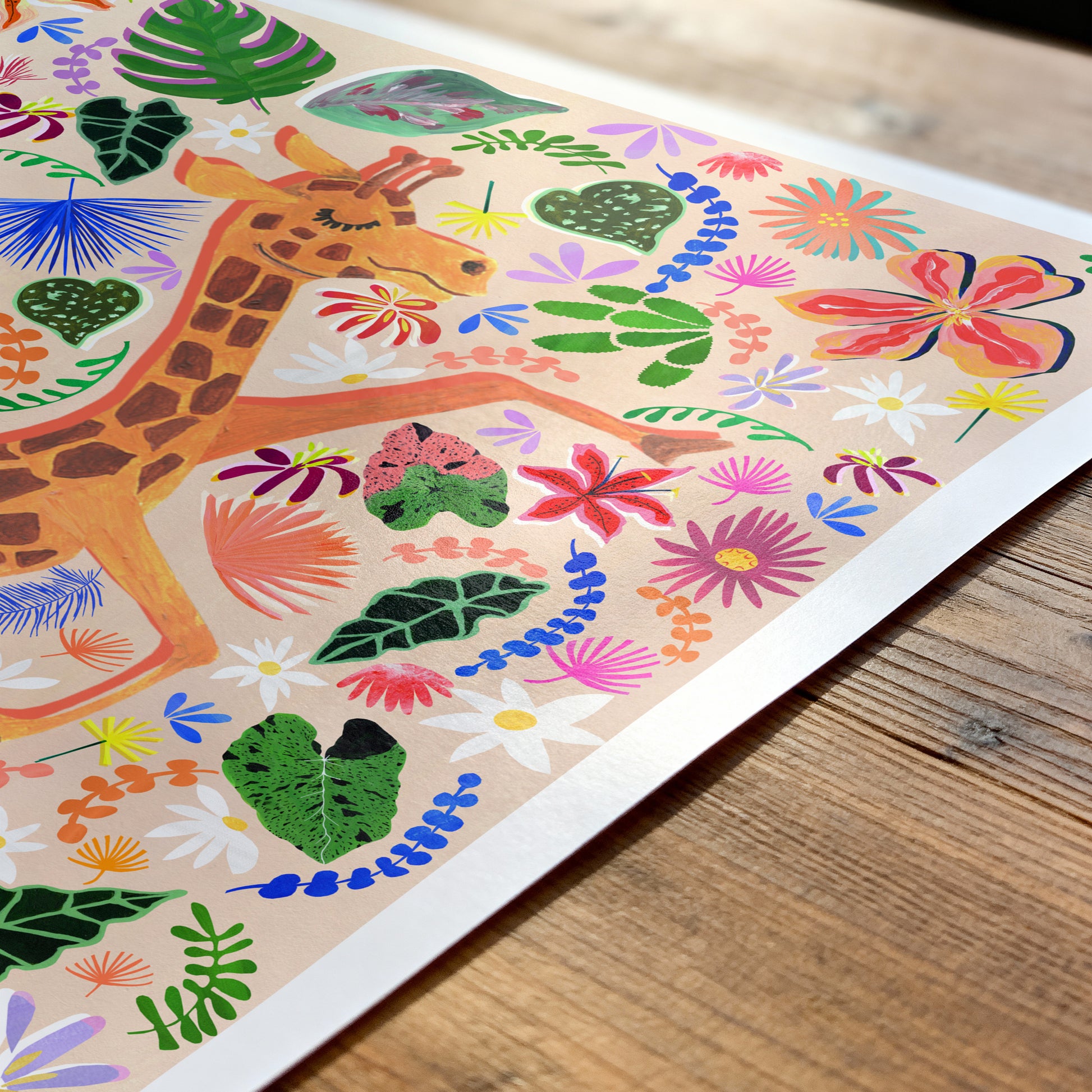 Colorful children's illustration of a giraffe and floral patterns on a wooden surface