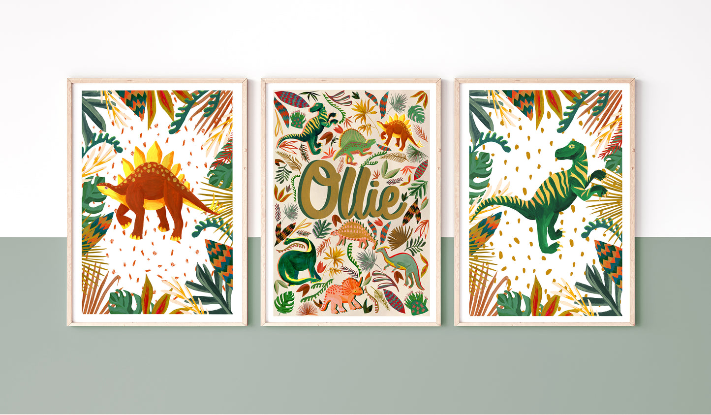 Earth toned Personalised framed name print set in a dinosaur illustrated theme place on a a colourblock wall with a stripe of dark sage green and white